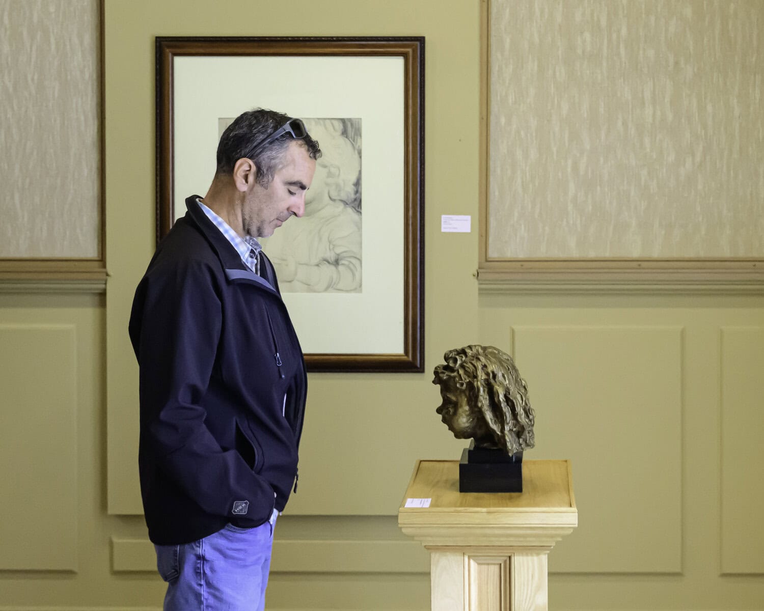 Jeremy Bowen of Thorold views a bronze statue of Sir Jacob Epstein at RiverBrink Art Museum. The sculpture is part of the museums collection celebrating influential figures in
art and history. 