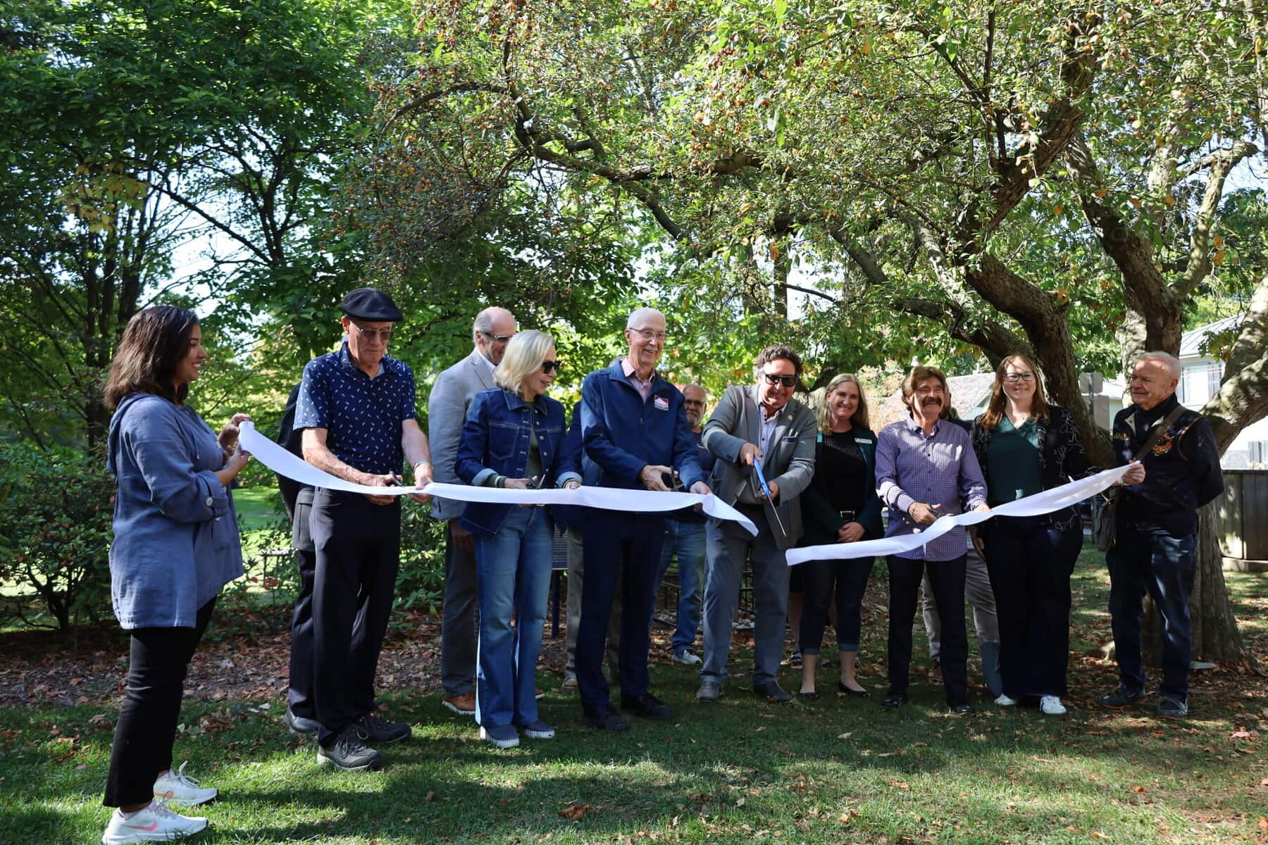 From left, town heritage planner Sumra Zia, retired land surveyor Richard Larocque, municipal heritage committee member Alexander Topps, Coun. Wendy Cheropita, Niagara-on-the-Lake Museum board director Ted Rumble, heritage committee chairperson Drew Chapman, Lord Mayor Gary Zalepa, Niagara-on-the-Lake Museum CEO and curator Sarah Kaufman, Niagara Falls MPP Wayne Gates, town director of community and development services Kirsten McCauley, and heritage committee member John Morley cut the ribbon Friday in Simcoe Park to celebrate the restoration of four historic boundary stones.