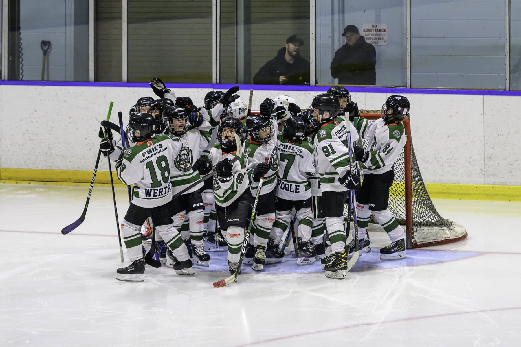 The U11 NOTL Wolves rally at the net ahead of their matchup against East Lambton, showing team spirit and focus before an eventual 8-3 defeat.