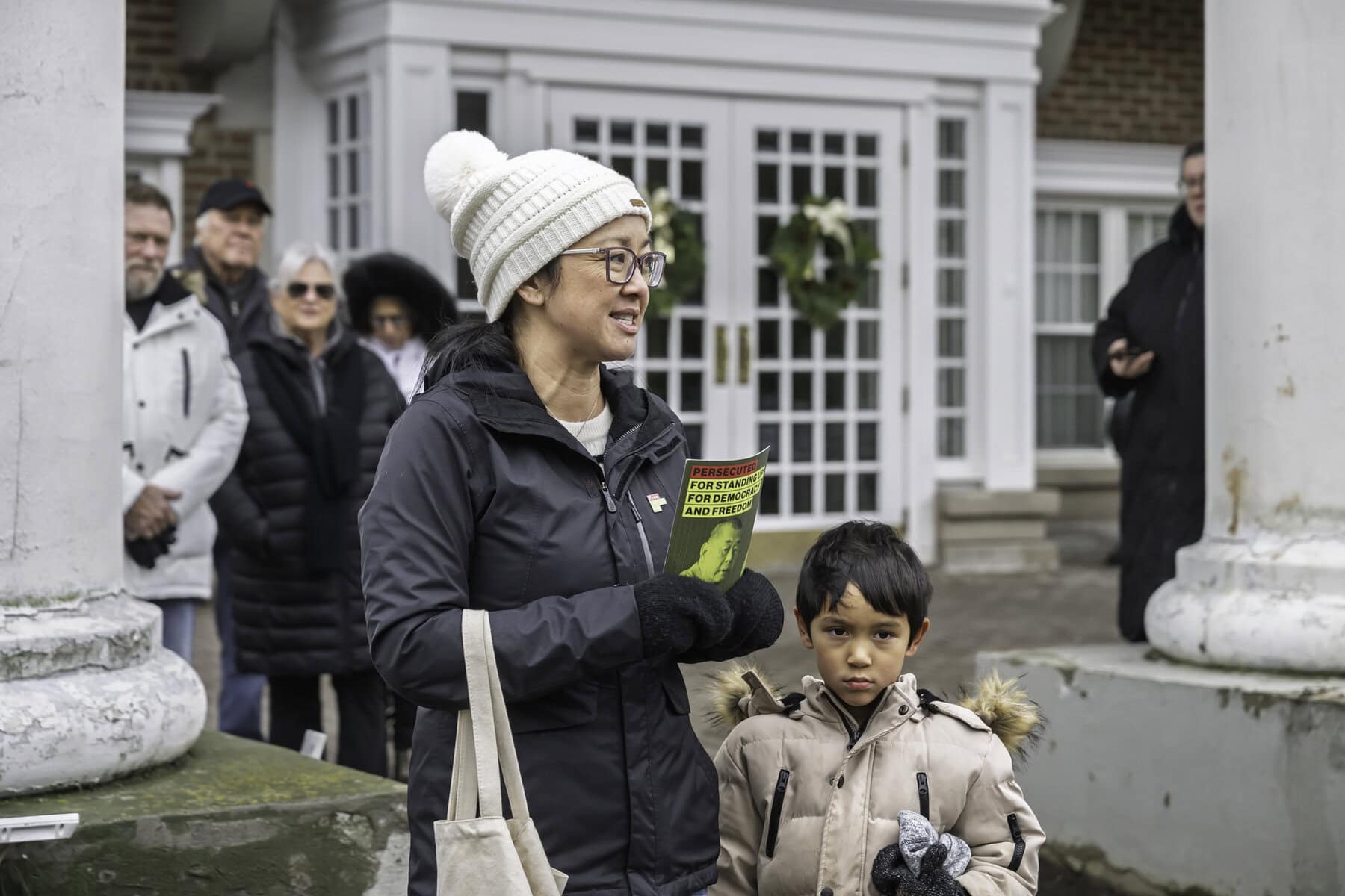Erica Lepp, niece of Jimmy Lai, addresses the crowd in front of the Queen’s Landing hotel, which Lai owns. 