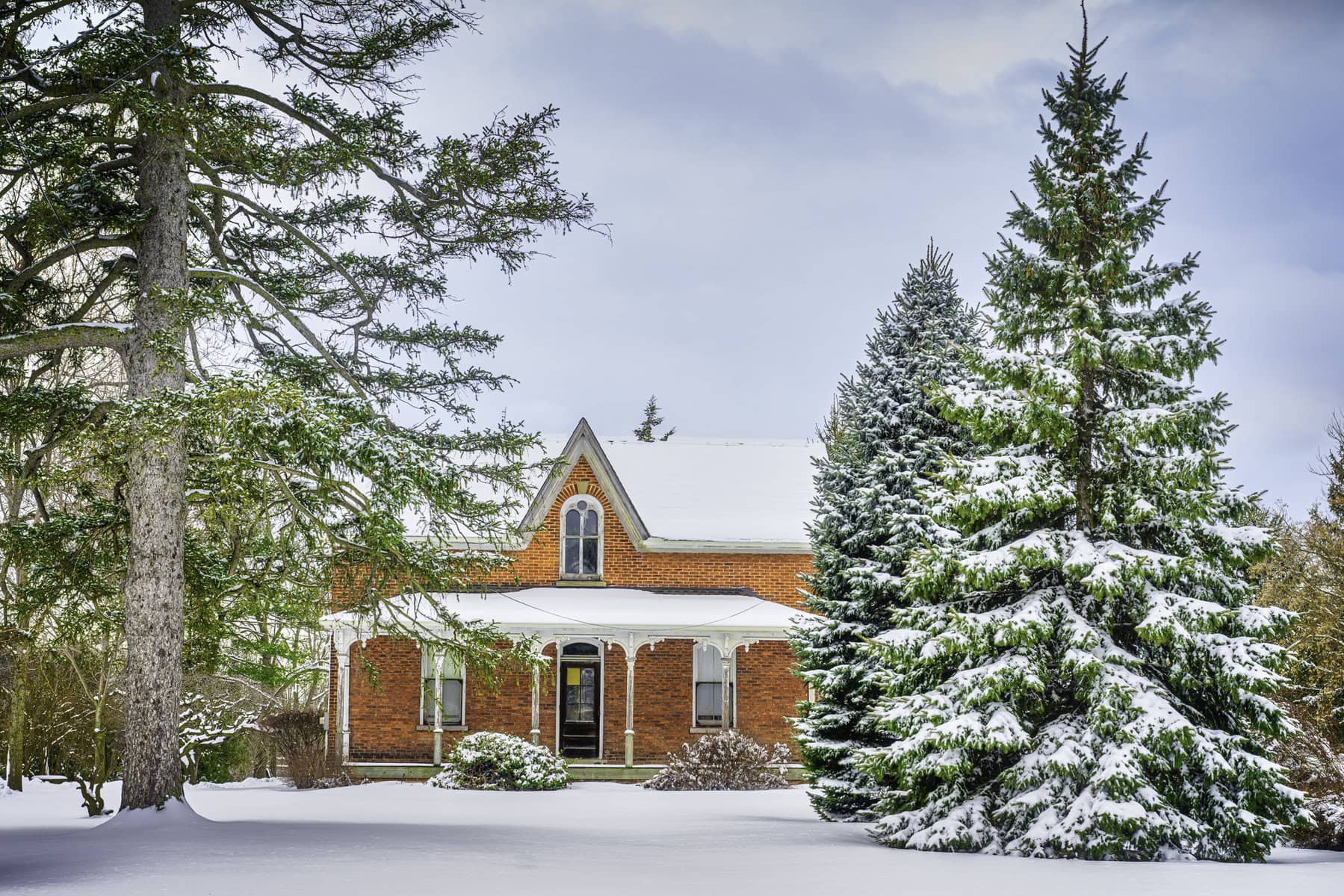 To open up the calendar for January, Dave van de Laar selected “a quiet winter portrait of a red-brick house nestled among the evergreens.”