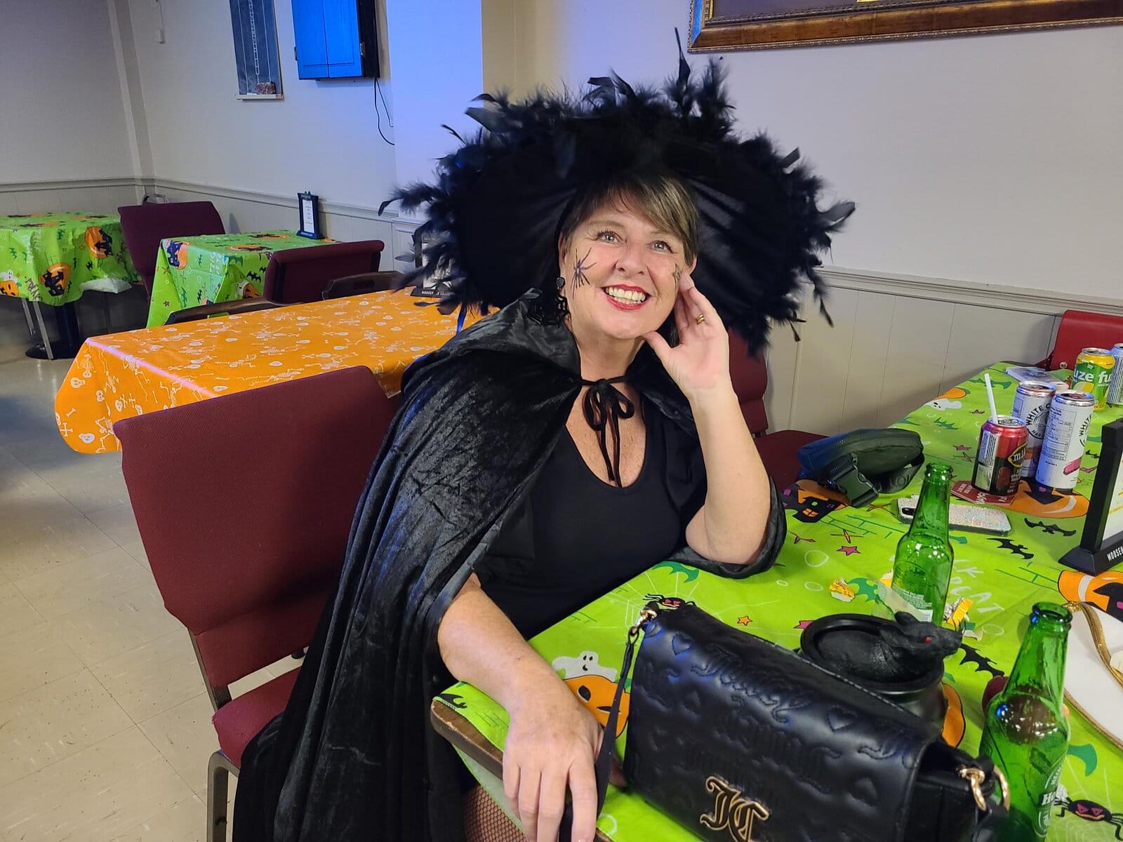 Rona Bloodhill, dressed as a witch, relaxes during the Halloween celebration at the Royal Canadian Legion’s “Scary-okey” night. 