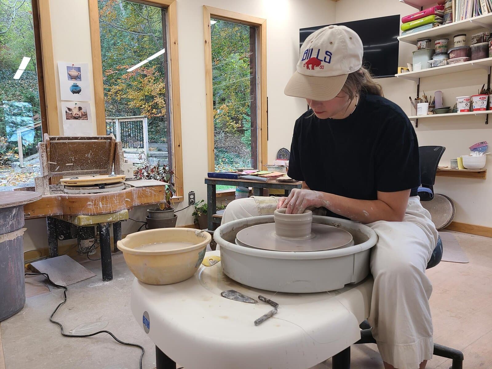 Studio potter Candace Boese works on the wheel during classes where she says many beginners discover the meditative side of clay. 
