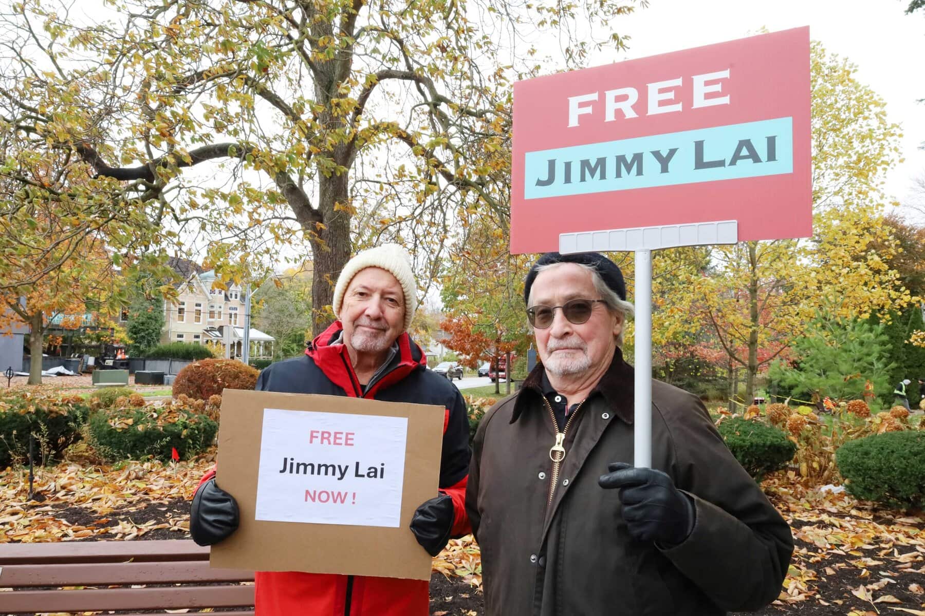 Supporters Bob Woodley, left, and Stephen Lunt advocate for Lai’s release during the protest. 