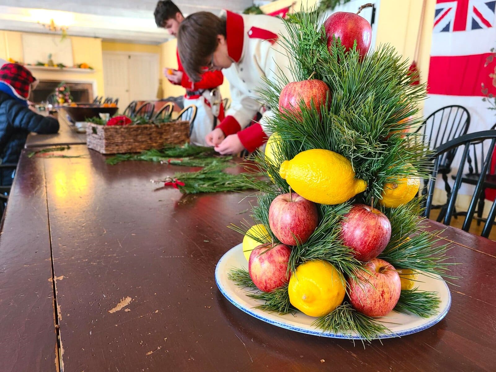 Citrus fruit served both as ornament and food, reflecting what families could import during winter after the harvest. 