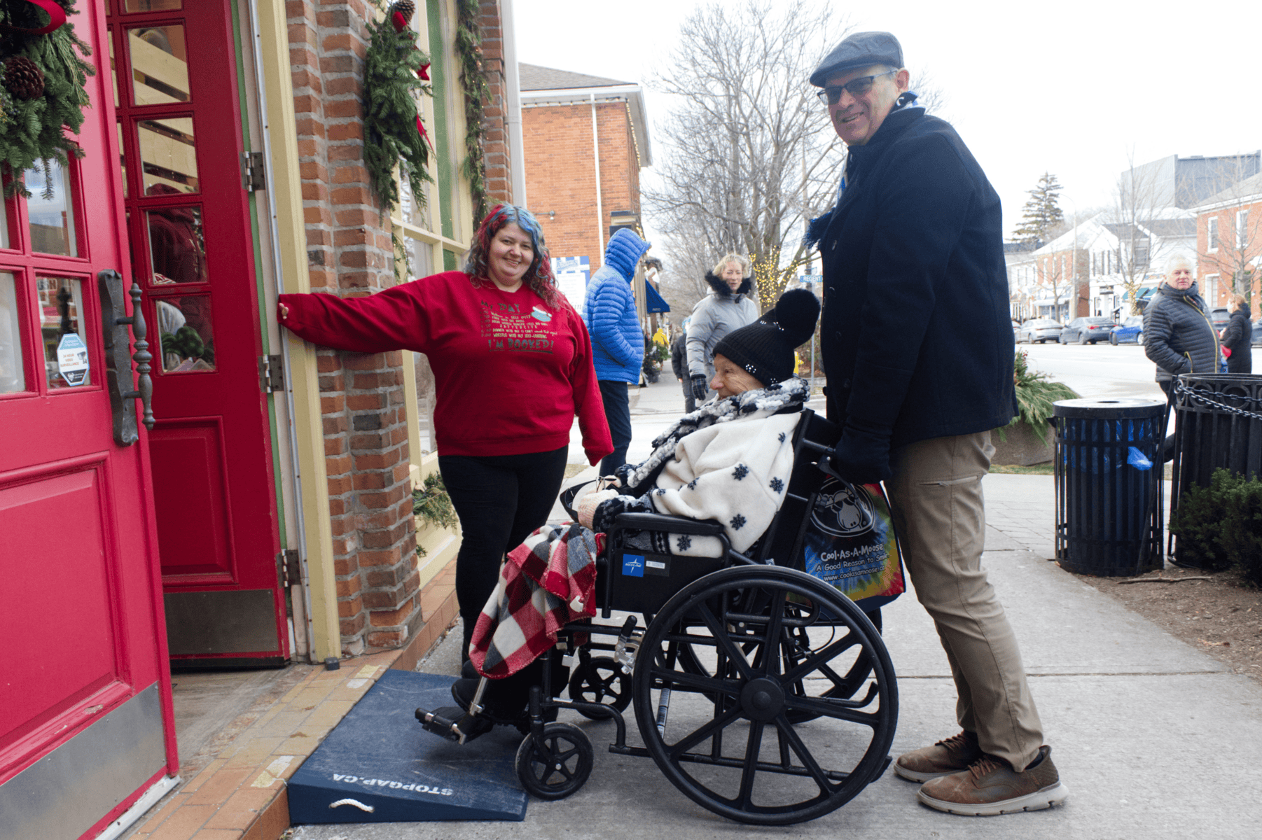 Jamie-Lynn Jones, manager of Cool as a Moose, shows Evelyn Frederick, from Maryland, and David Doermann of Buffalo over what allows Frederick to get into their new StopGap ramp, which arrived on Friday. 