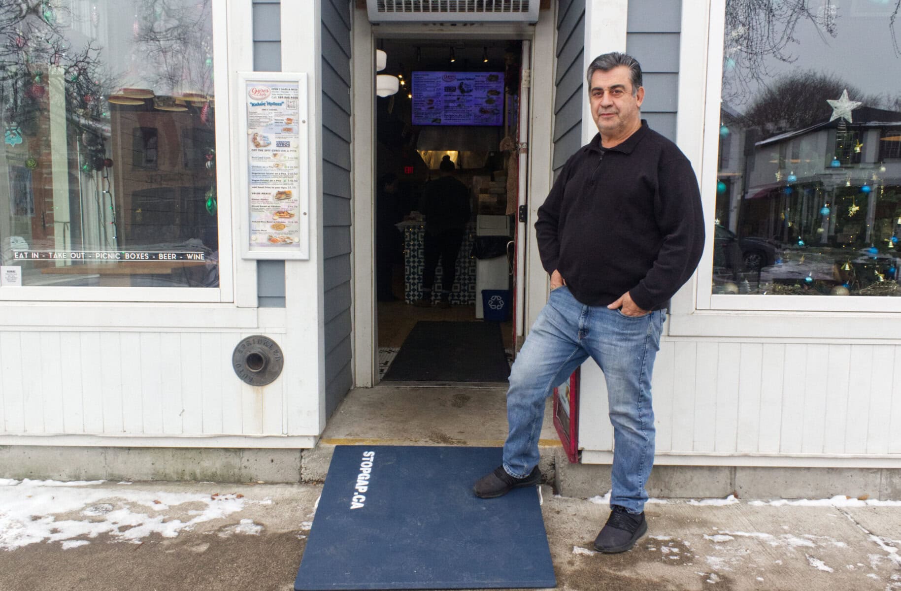John Paraskevopoulos, owner of Gyros on the Lake, is one of nine businessowners who have an accessible ramp allowing them to get over their single step, which they received on Friday. DAN SMEENK