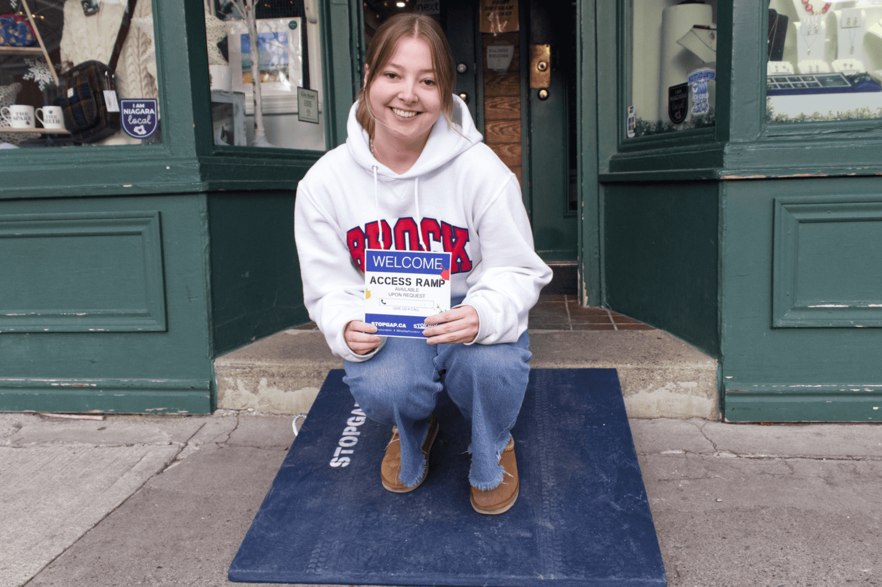 Lauren Davidson, cashier at Scottish Loft, is part of one of nine stores in NOTL to receive a StopGap ramp on Friday. Davidson also shows how customers can get a hold of staff if the portable ramp is inside.
