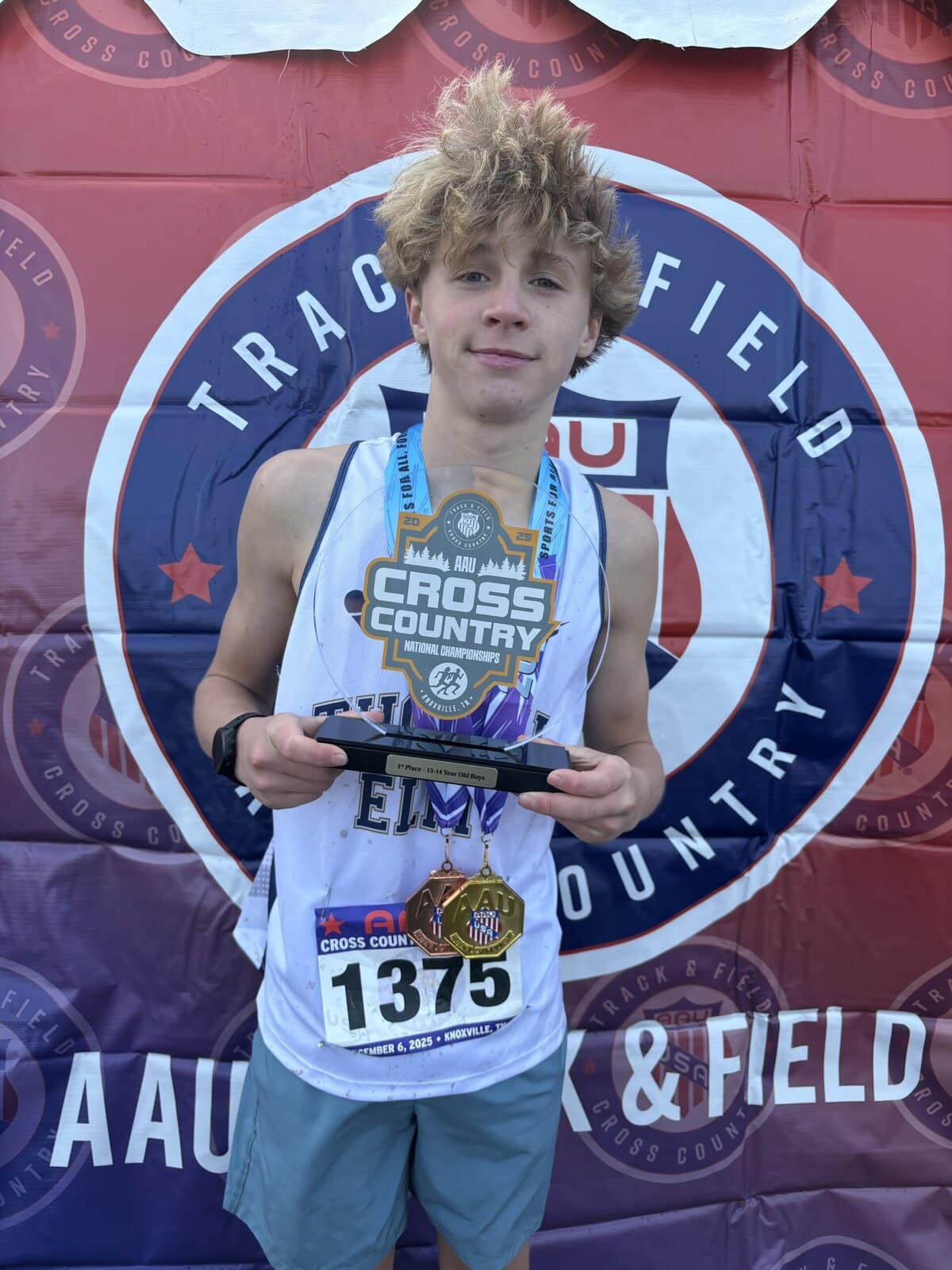 Luke Simpson holds the first-place team trophy from the U.S. national championships.