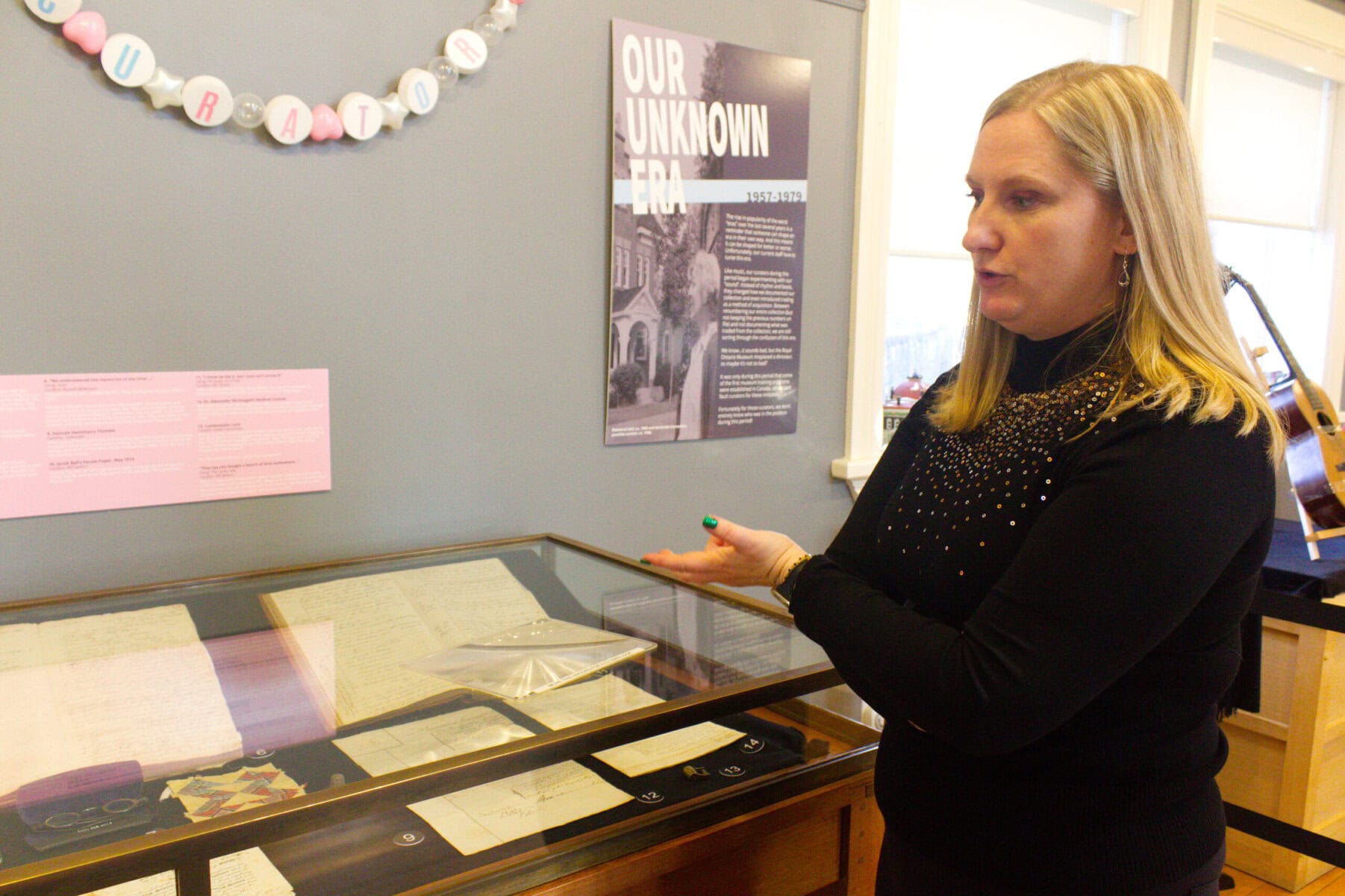 Outgoing NOTL Museum CEO and curator Sarah Kaufman in Memorial Hall showing museum items on Friday on a day when the museum celebrated its 130th anniversary.