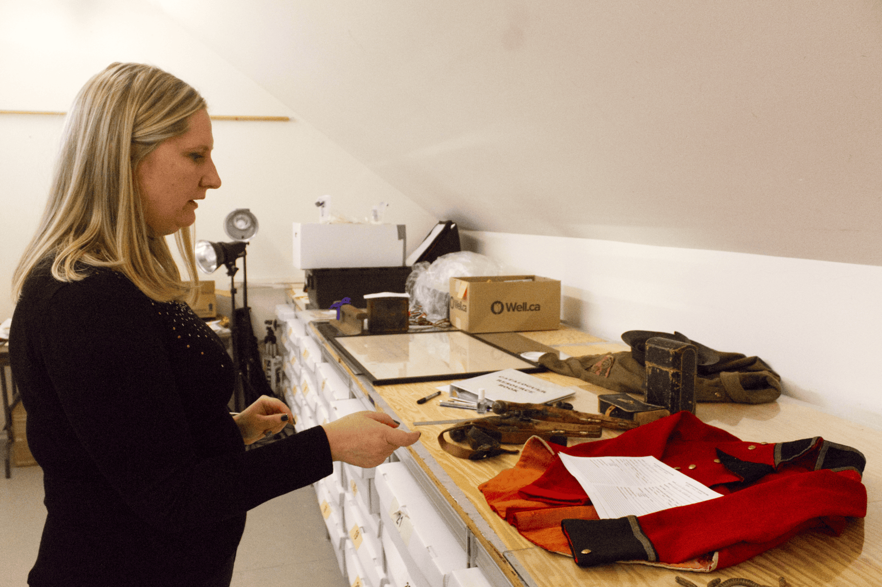 Outgoing NOTL Museum CEO and curator Sarah Kaufman showing off an original War of 1812 British redcoat in the museums storage area on Friday when the museum was celebrating its 130th anniversary. 