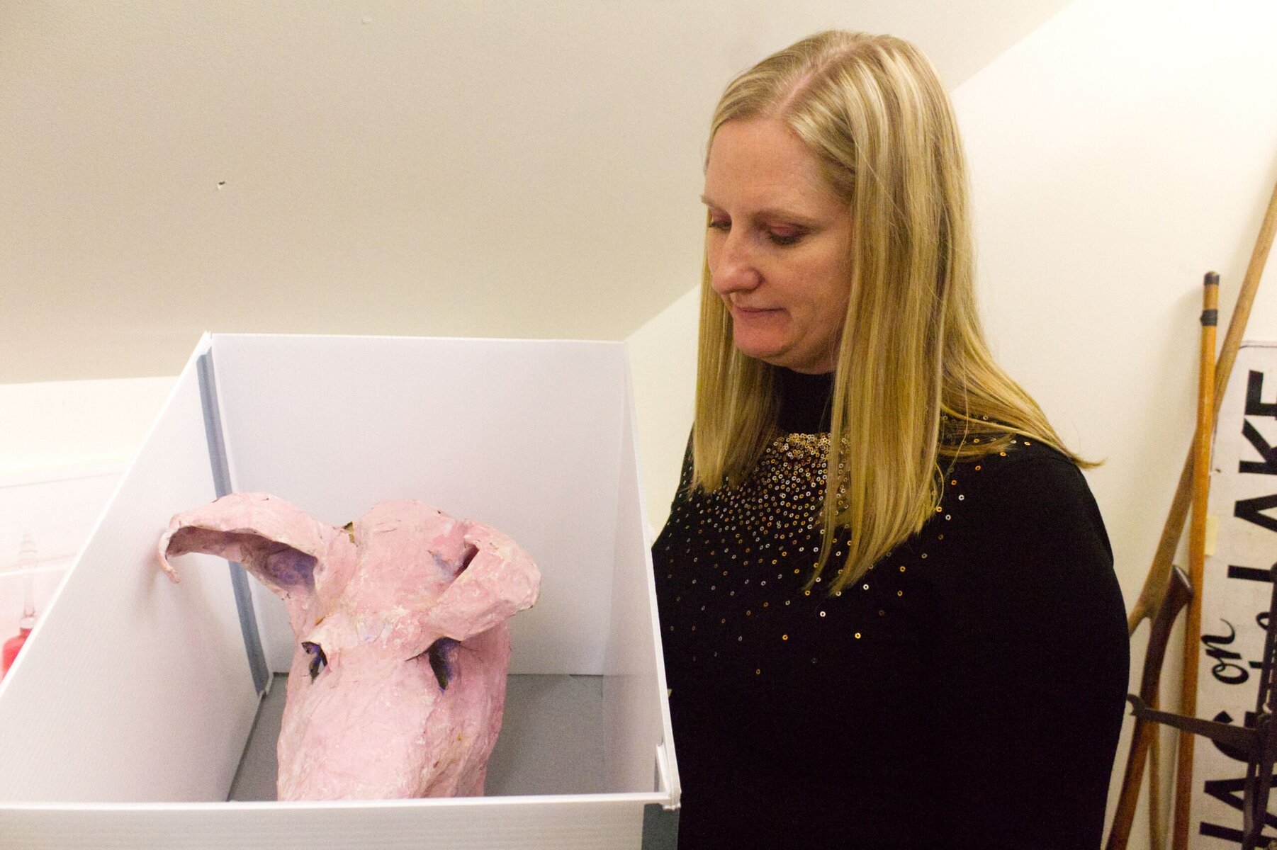 Outgoing NOTL Museum CEO and curator Sarah Kaufman showing an early Shaw Festival show's pig's head on Friday on a day when the museum celebrated its 130th anniversary. 