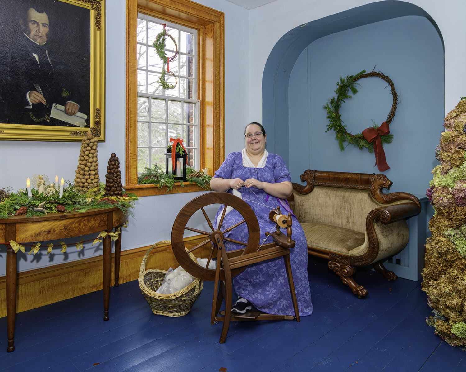 Over at the McFarland House on the Holiday House Tour, Danielle Lamoureux busies herself in the corner spinning wool into yarn.