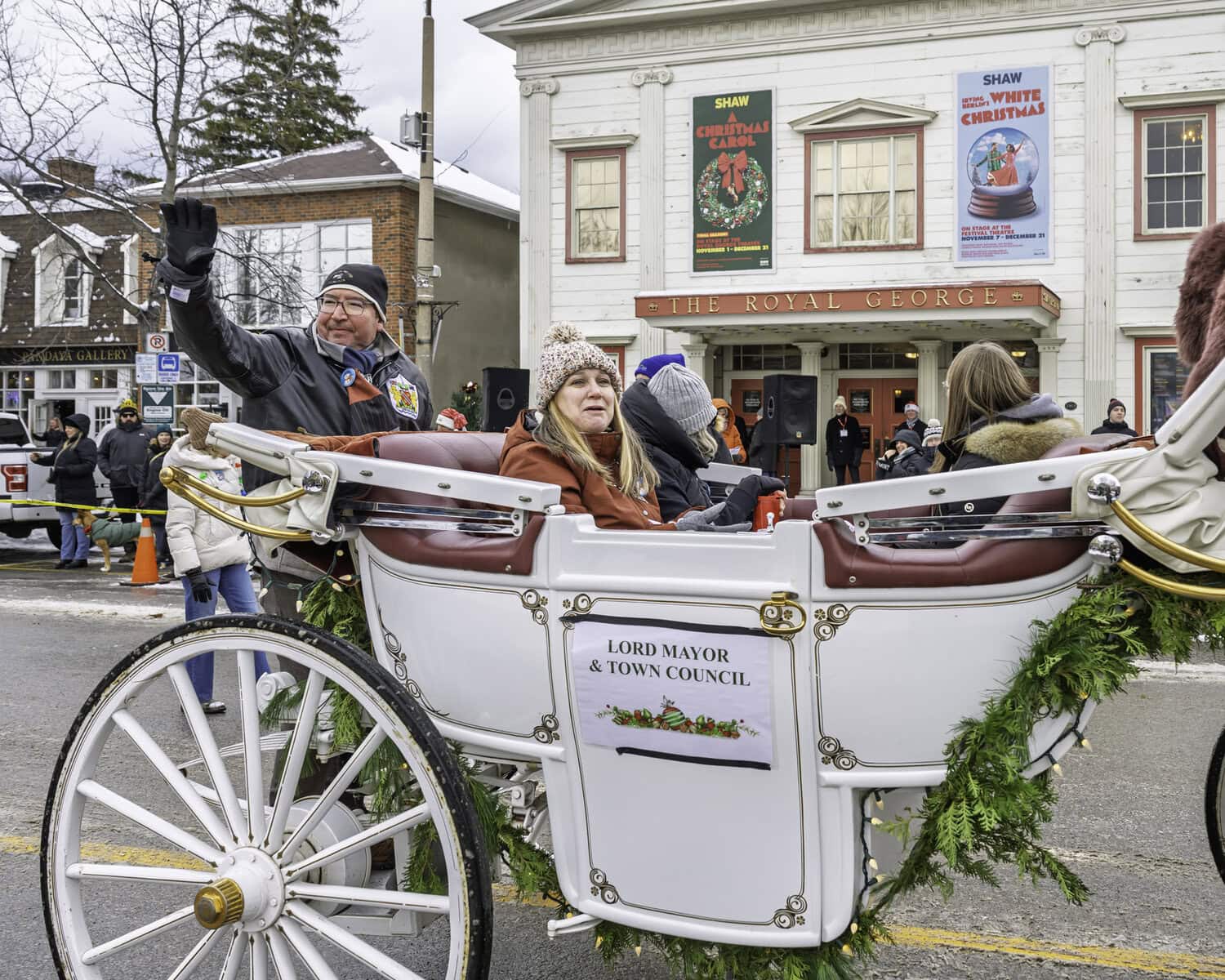 The leader of the community, Lord Mayor Gary Zalepa, waves to onlookers as his carriage passes the Royal George Theatre.