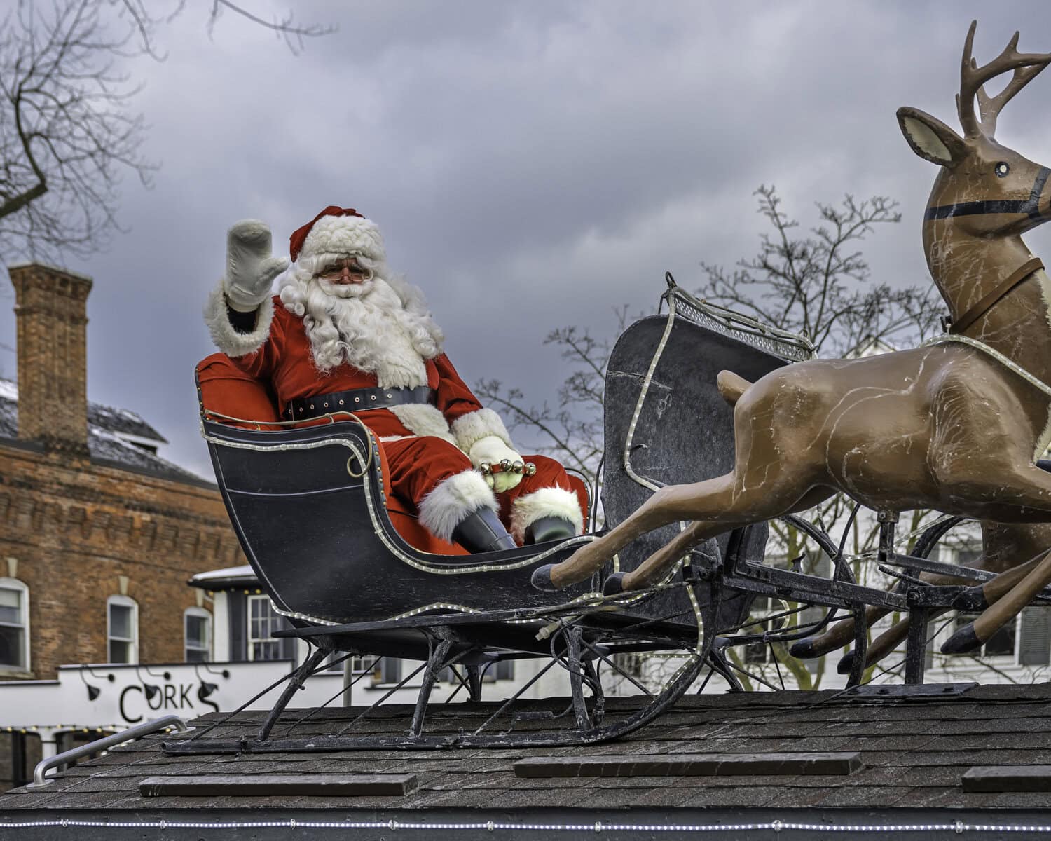 Ho, ho, ho, NOTL! Santa Claus waves hello to parade attendees as he passes through Queen Street on his sled.