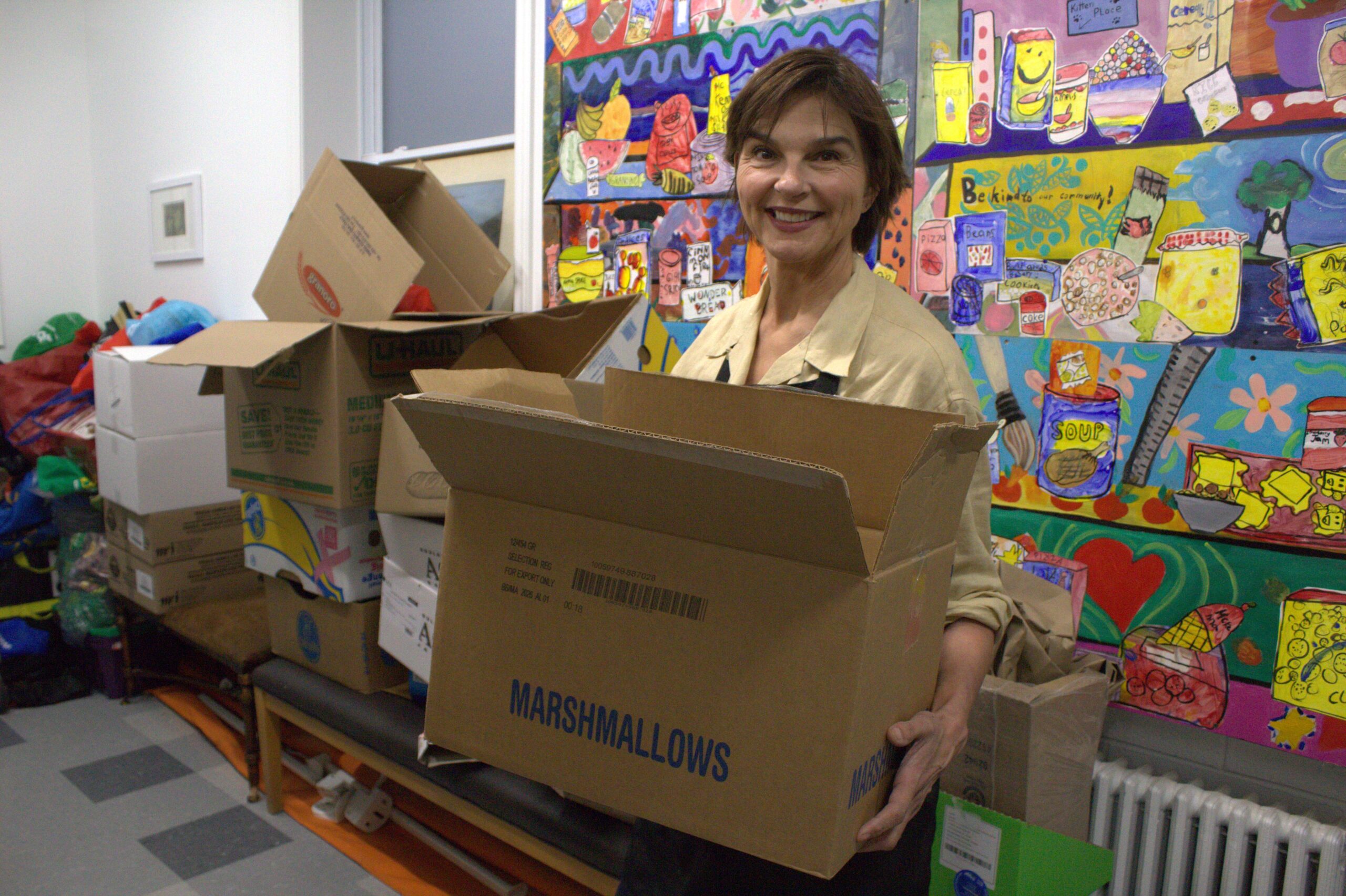 Yvonne Causer, board member of Newark Neighbours, shows what is recycled from her organization. The organization's director Cindy Grant says the blue box privatization will impact the food bank.