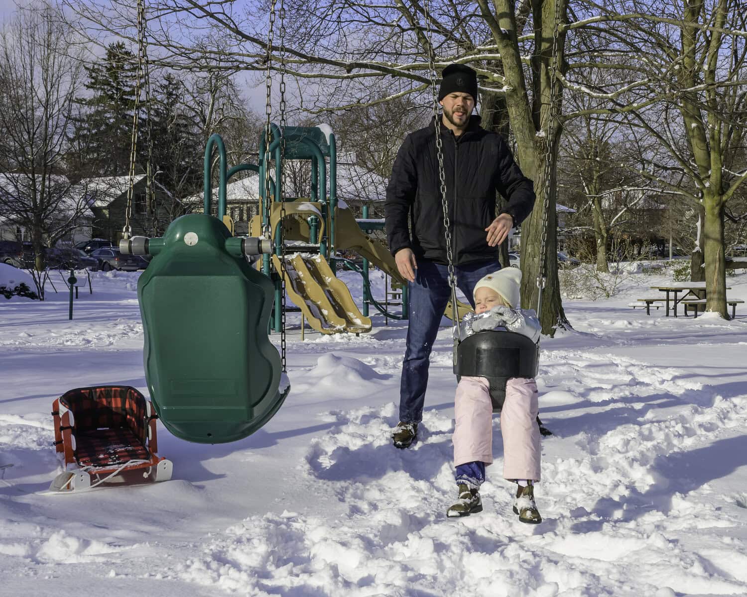 Despite Sunday's frigid conditions, Vivienne Hawkswell and her father, Adam Hawkswell, enjoy an afternoon together at Simcoe Park.