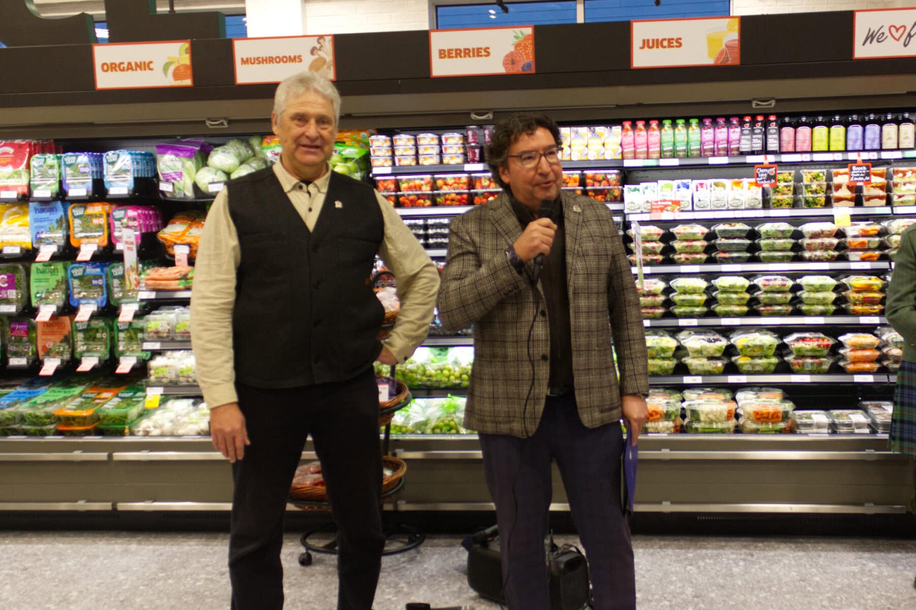 Coun. Erwin Wiens, left, and Lord Mayor Gary Zalepa help usher in the new Foodland store in Garrison Village during their grand opening on Thursday.