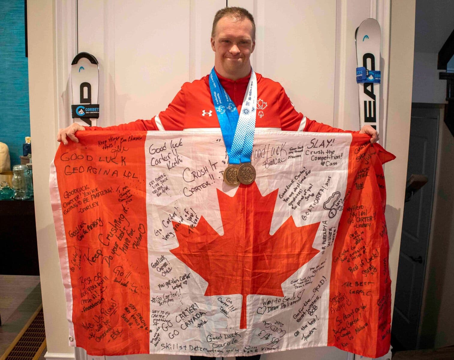 Carter Simpson proudly holds a Canadian flag signed by his Good Life spin class.