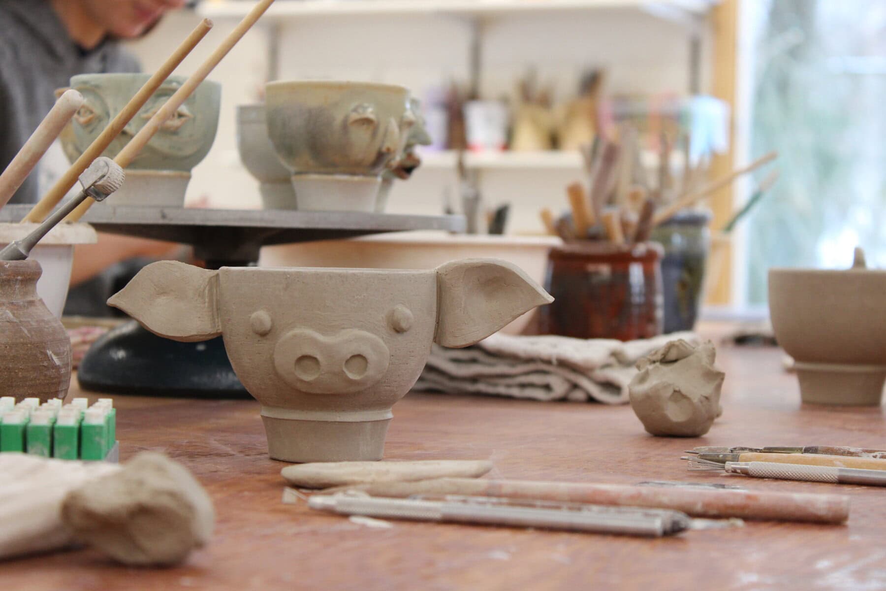 Elka Kroch made a pig-shaped face cup which will then be glazed and fired at the Sunday workshop at Queenston Pottery.