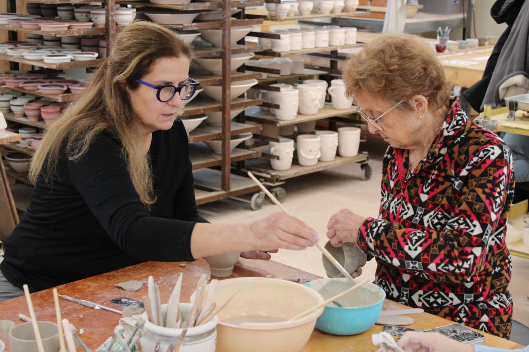 Elka Kroch learns with Queenston Pottery co-founder Eva Mlcak to sculpt face cups at the workshop last Sunday.