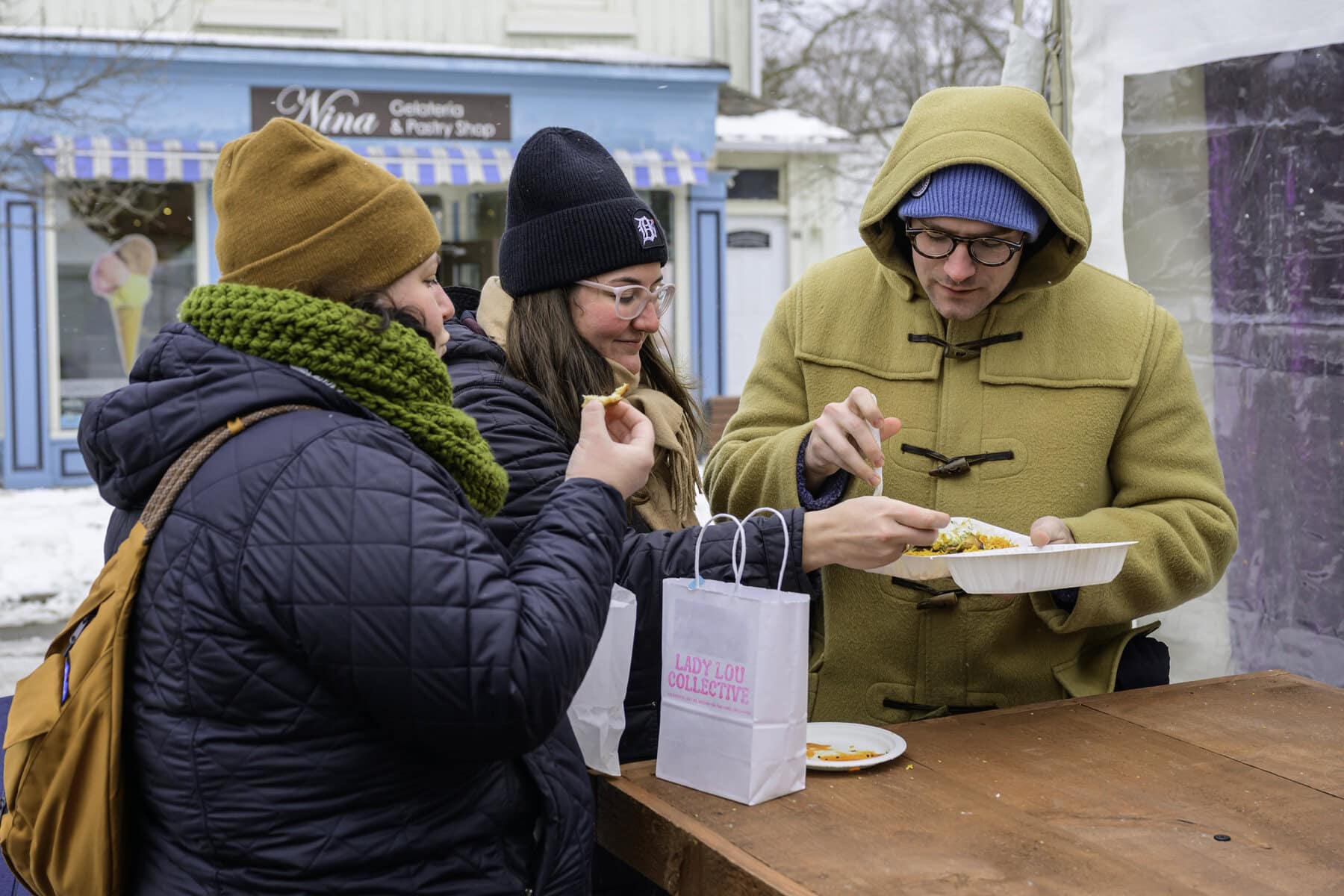 Something sweet goes great with a little heat: Hannah, Carly and Evan Finnegan enjoy tandoori chicken leg with biryani rice from nearby restaurant Aura On The Lake at the festival.