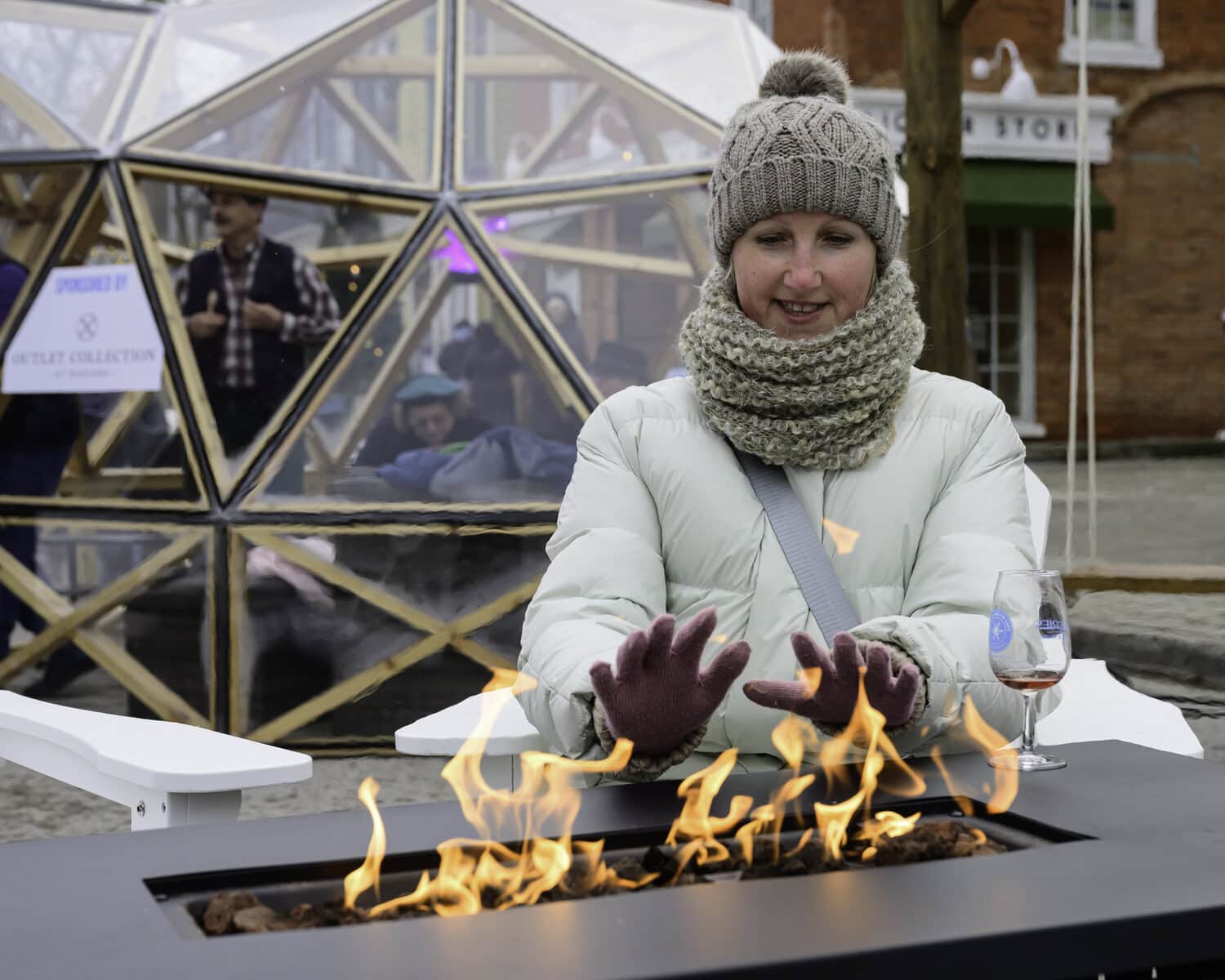 Helen Sokol avoids the worst of the frigid winter temperatures by keeping warm beside the fire.