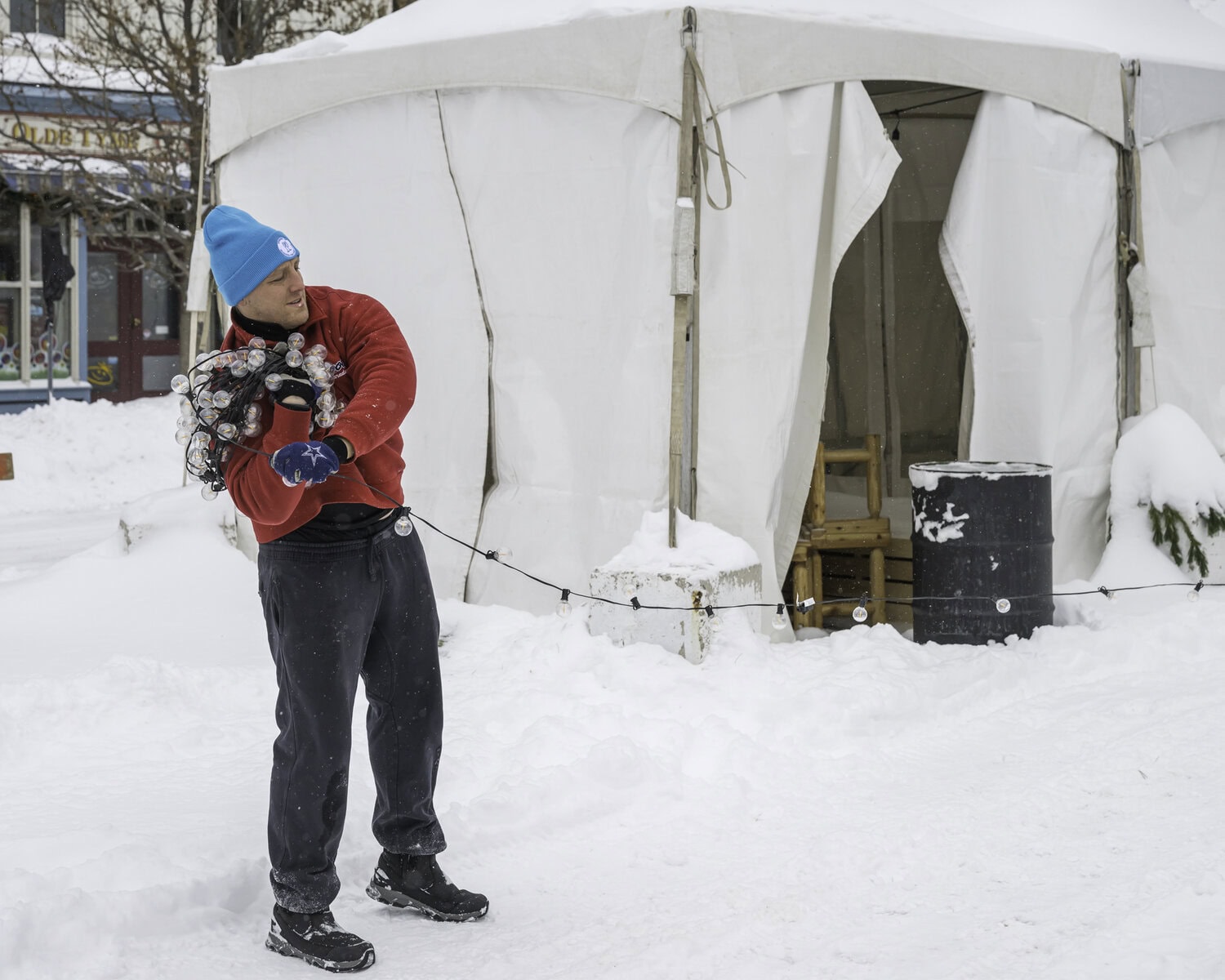 With no Icewine Village on Sunday due to the snow storm, Icewine Festival workers and volunteers spent the day taking down the village's booths, seating arrangements and decor. Here, Jamie Singleton gathers up the village's lights.