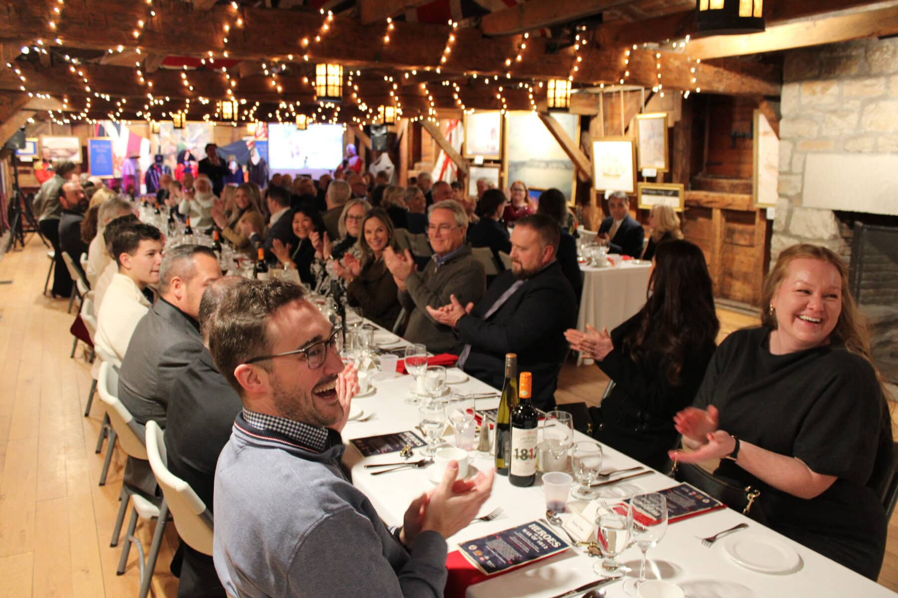 People applaude Friends of Fort George executive director Amanda Gamble for her work putting on the event at Navy Hall for the Heroes of the War of 1812 Lord Mayor's charity dinner on Saturday.