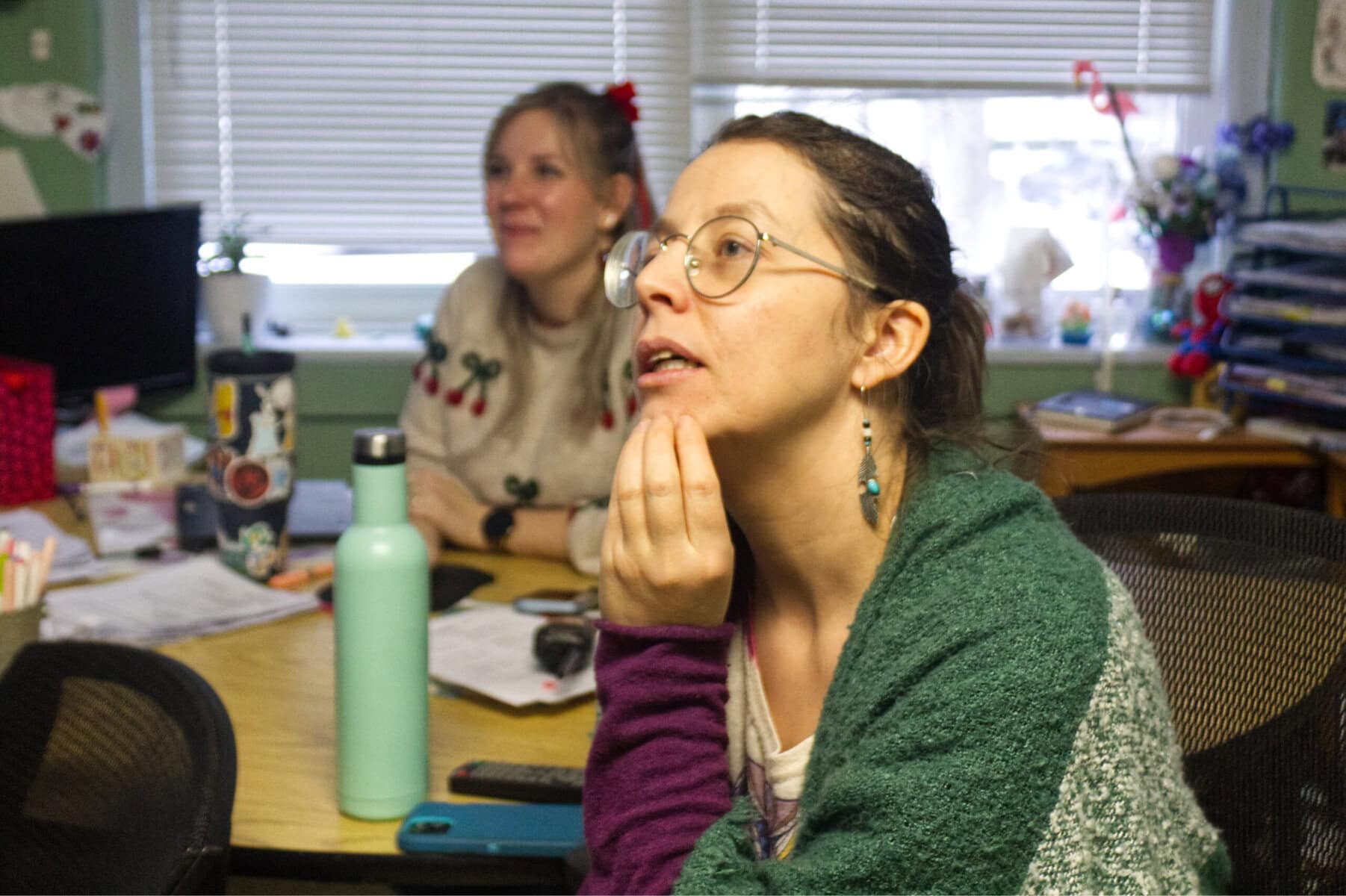 Royal Oak teachers Morgane Chaudoreille, in front, and Brittany Nyenhuis watch the Canadian and American women's teams square off in the Olympics on Tuesday, part of how they are bringing the Olympics to Royal Oak School.