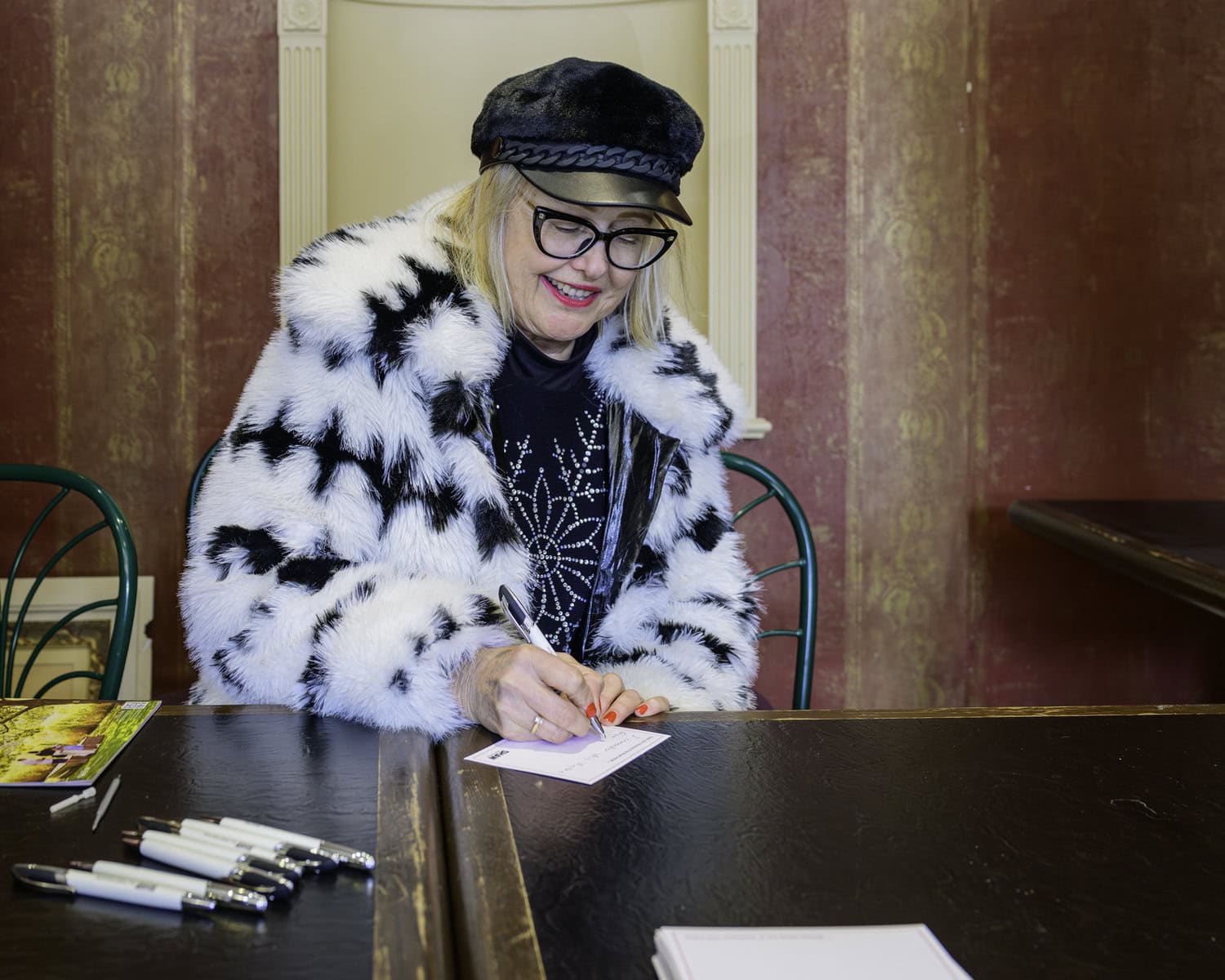 Outside the auditorium, Phoebe Knauer writes down a memory of her time at the Royal George Theatre, which the Shaw solicited from the people who dropped by on Saturday afternoon.