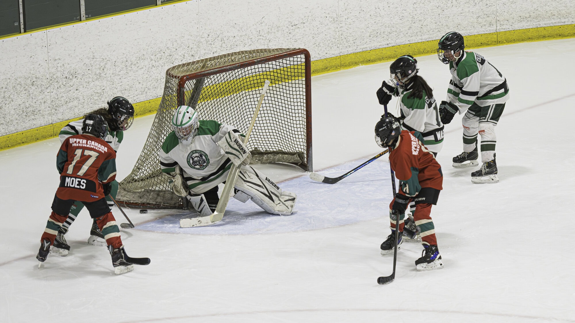 NOTL team #2's Sawyer Moes and Caden Hielema get up close and personal with team #1's goalie, Taylor Steele.