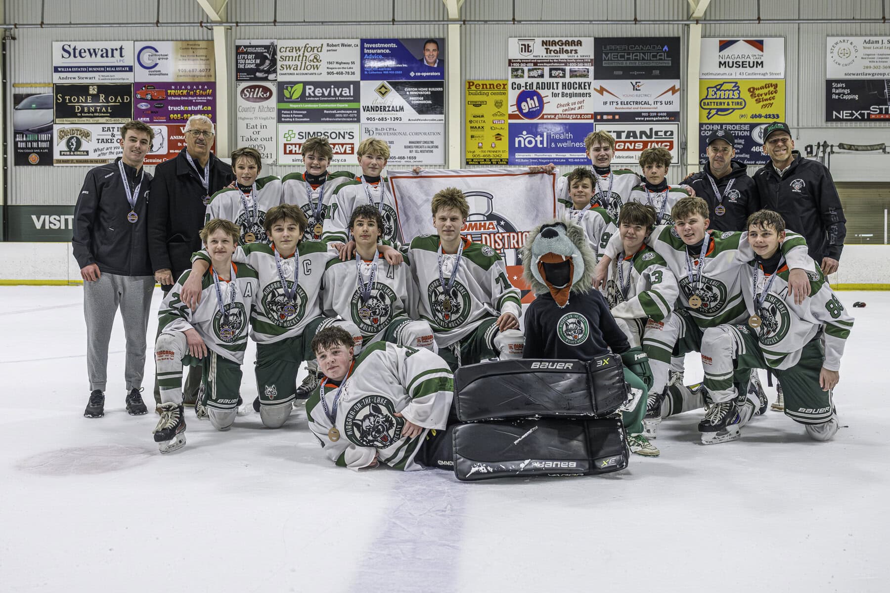 Players and coaches of the U15 NOTL Wolves team celebrate their Niagara District
championship win over Port Colborne last Wednesday night.