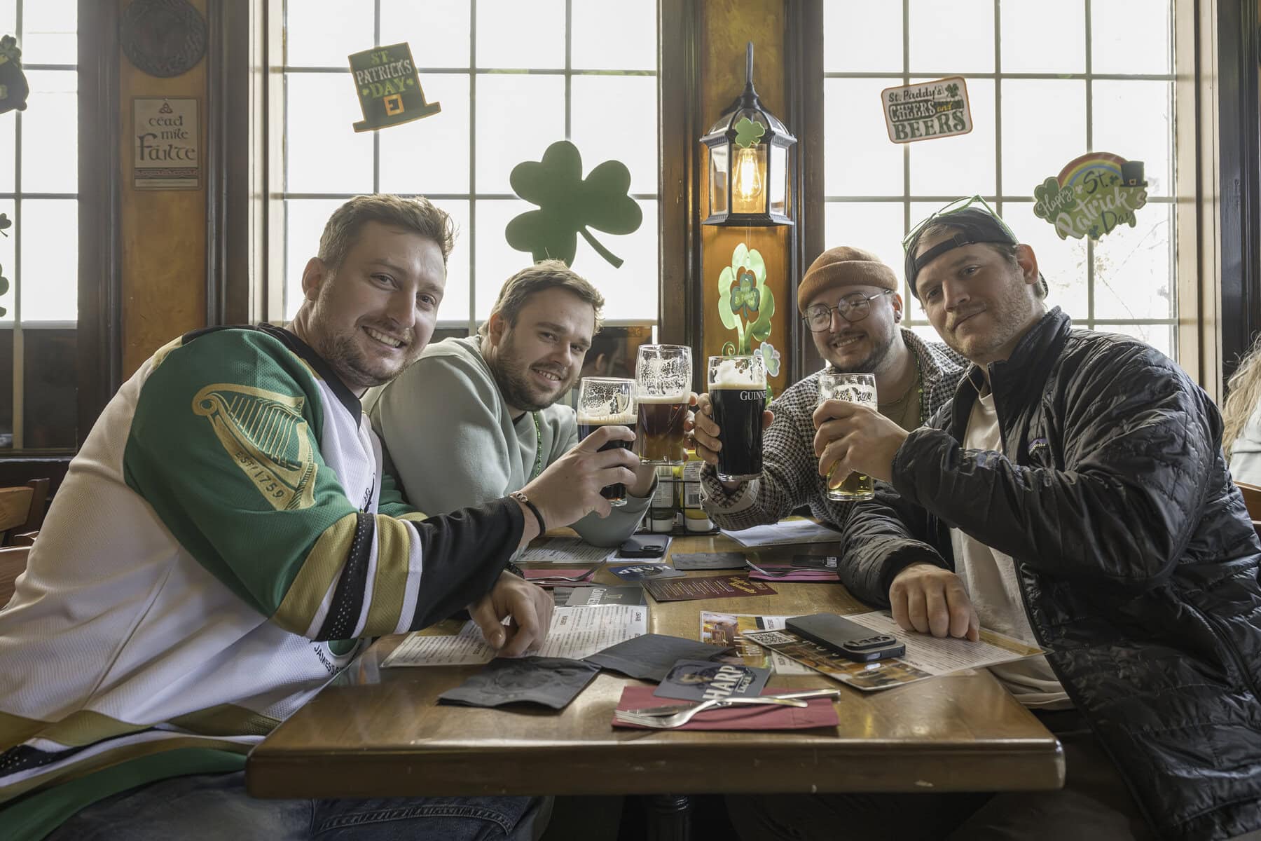 Raise a glass to friendship — and Guinness: Damen Nyland, Taylor Perry, Ryan Ravelle and Corey Gorbell enjoy St. Paddy's Day at the Irish Harp.
