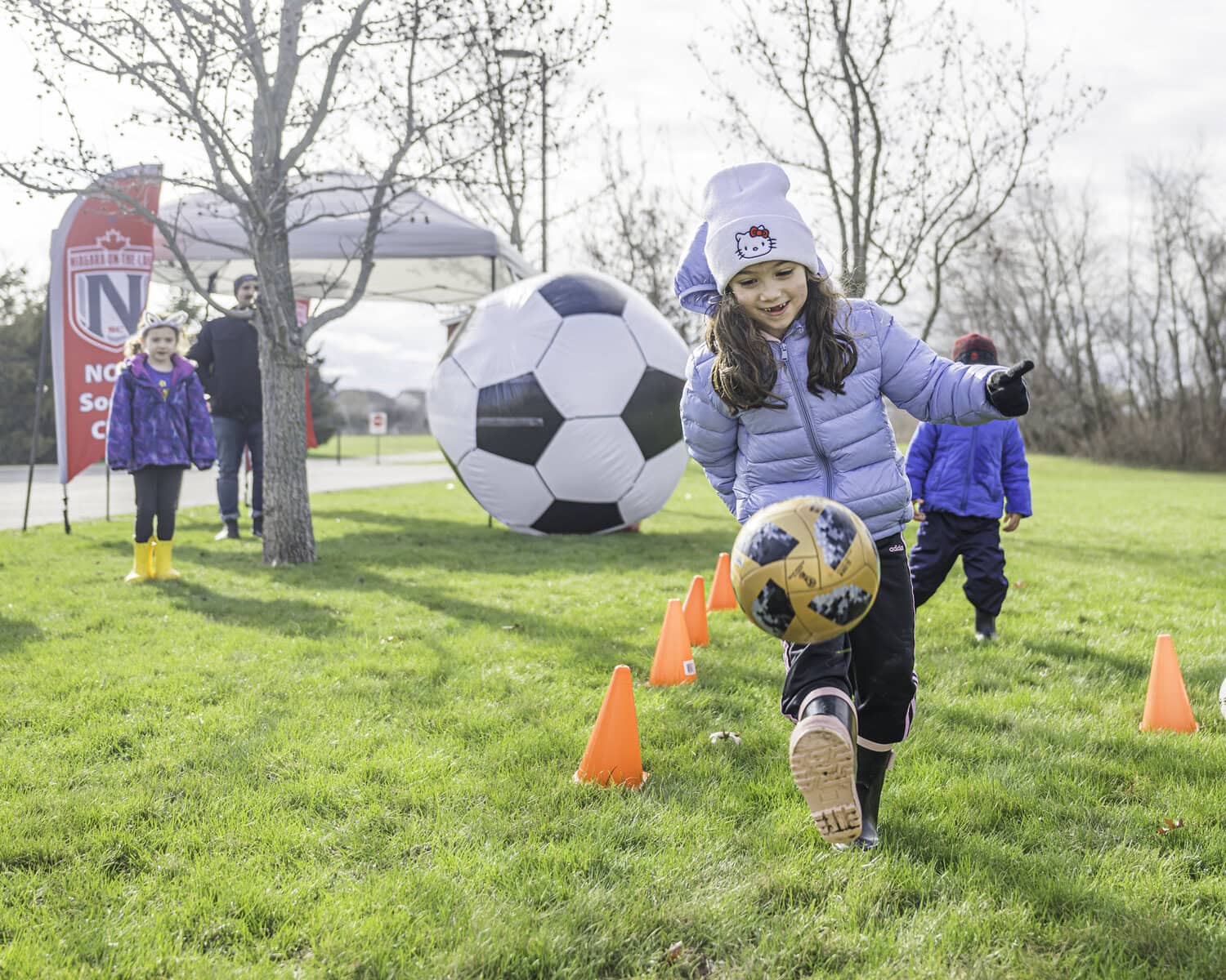 Six-year-old Mikaela Allen plays in the soccer course outside the community centre, hosted by the NOTL Soccer Club.