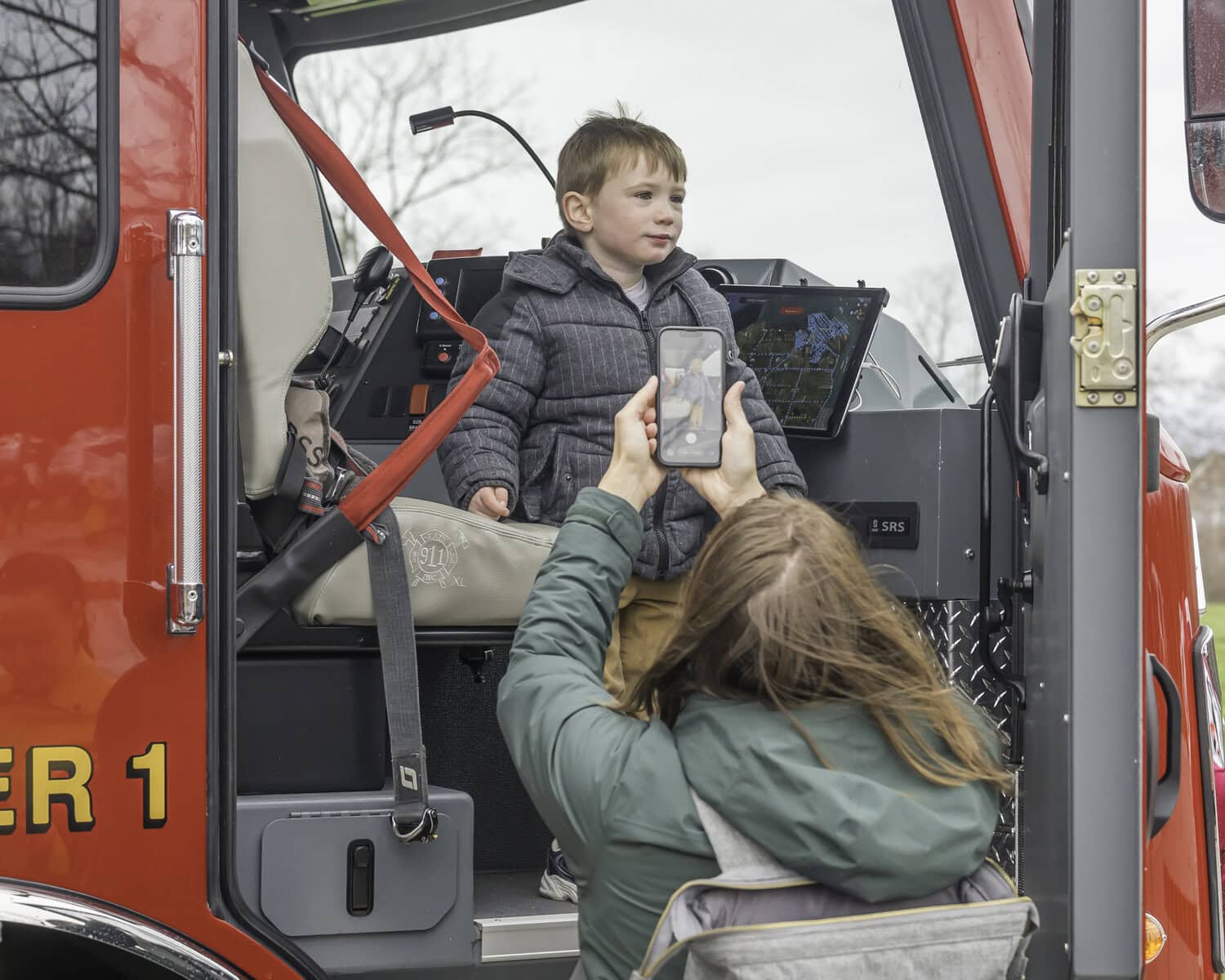Mon-Anna Tattersall snaps a picture of her three-year-old son, Logan Tattersall, in a firetruck. NOTL Fire Services were on the scene with the touch-a-truck area.