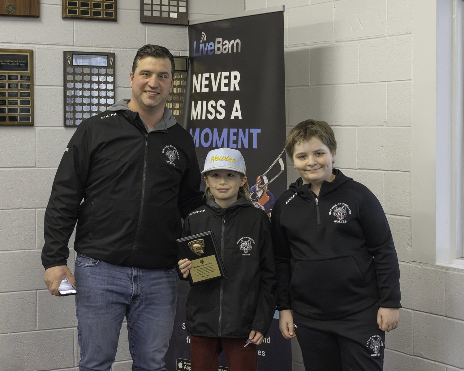 NOTL Minor Hockey Association vice-president and U13 rep team coach Gary Friesen congratulates Mike Moore on receiving the goalie award. At right is last year's winner, Michael Duc.