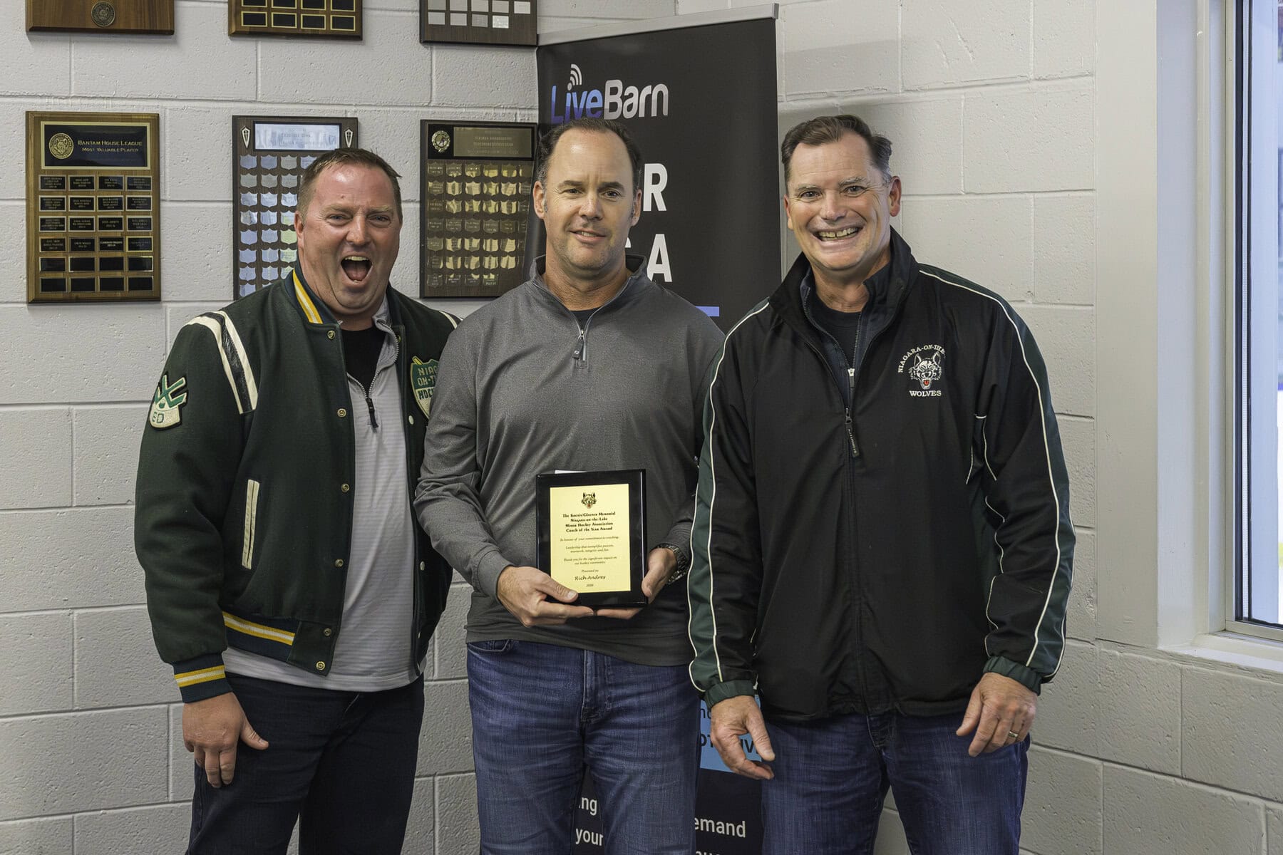 Paul Kocsis, left, and Carl Glauser, right, present the Coach of the Year Award to Rich Andres. 
