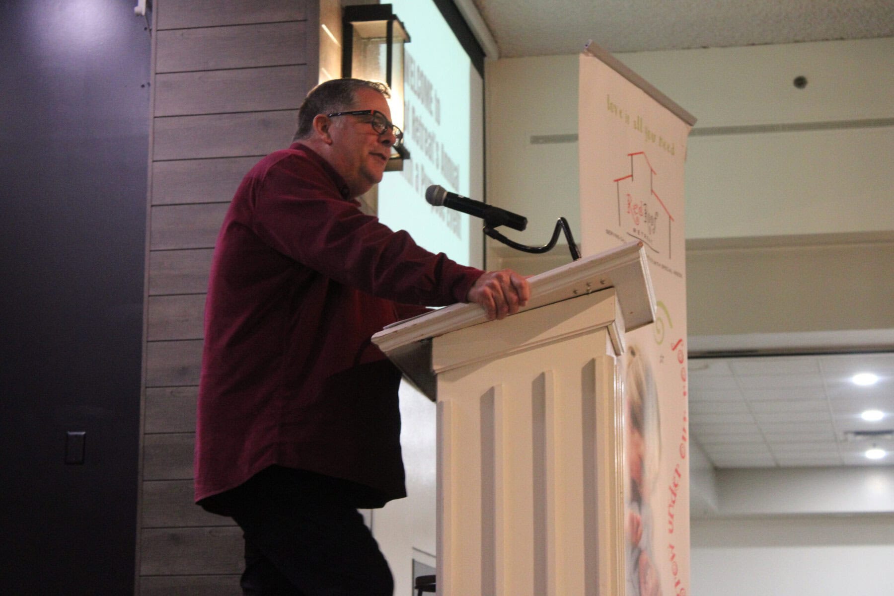 Red Roof Retreat board member and event host Ken Hendricks addresses supporters during the annual Pasta Dinner fundraiser.