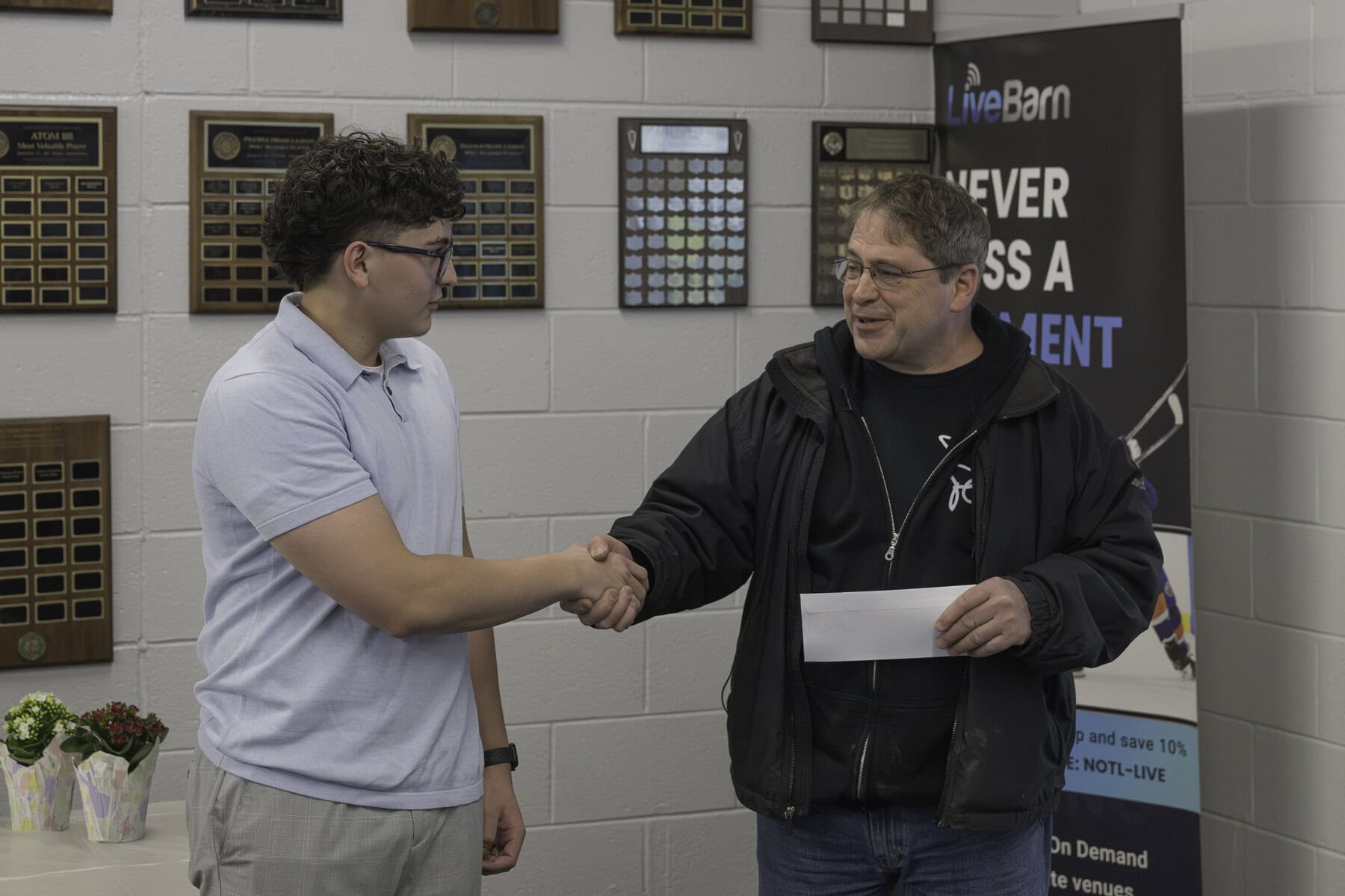 Thomas Munera is presented with the Virgil Business Association Scholarship Award by Phil Leboudec. The scholarship is for a post-secondary student who is going to be studying business.