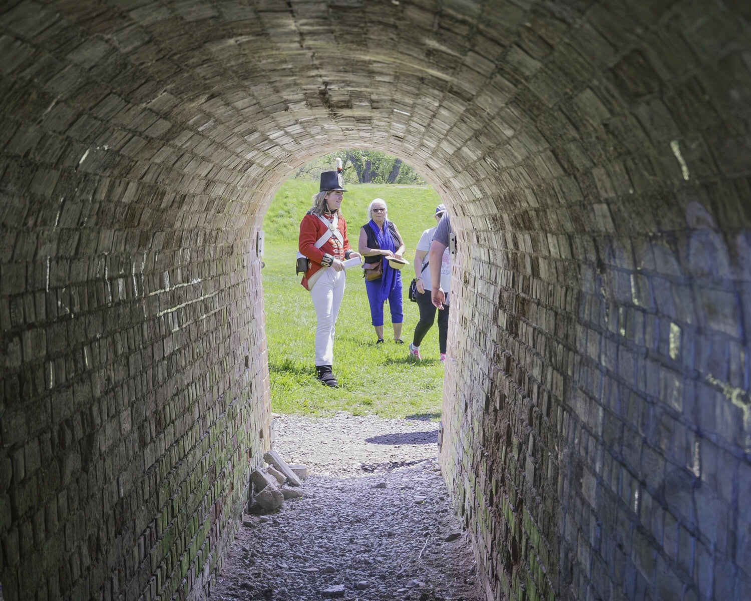 Gavin Watson, a historical re-enactor, shows visitors the entrance to the Sally Port, a a controlled, arched tunnel entry through the fort's star-shaped earthworks.