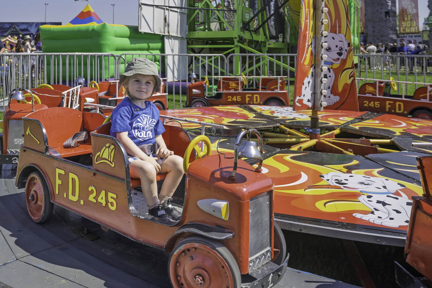 Over at this fire truck ride, Hank Leifso, 2.5, looks
like an honourary member of our volunteer fire department. 