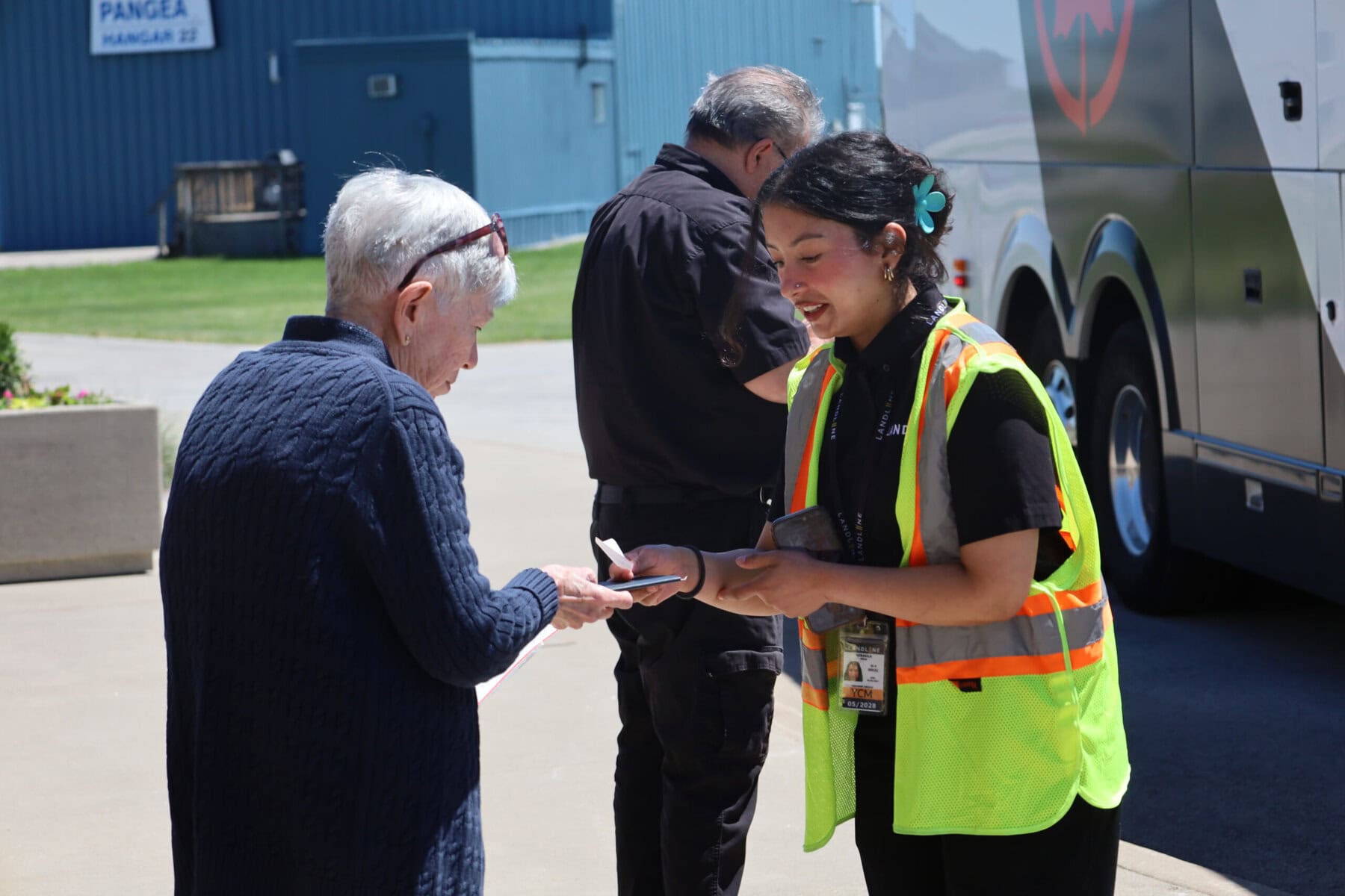 Landline’s Alina Niraula checks a traveller’s boarding pass during the first day of Air Canada Landline service at Niagara District Airport on Monday.