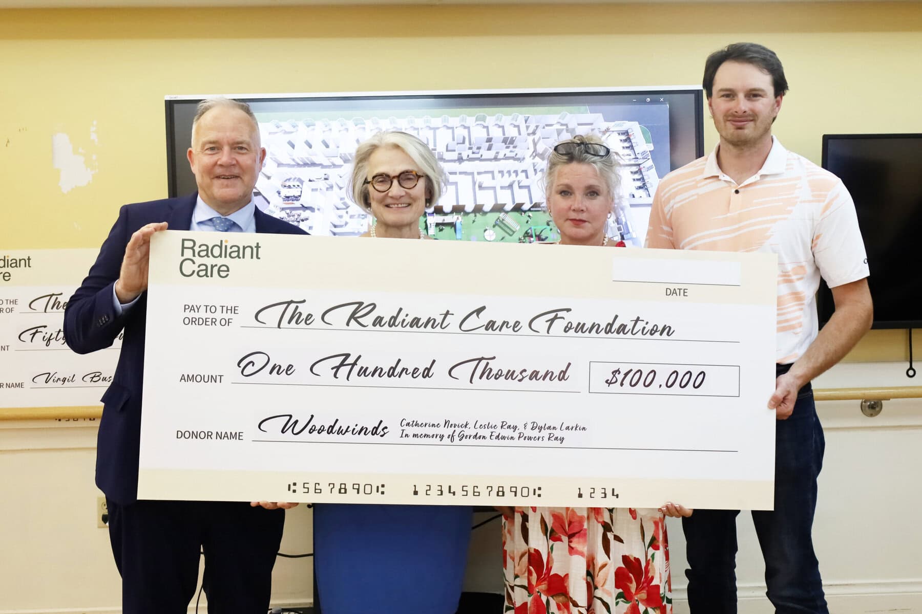 Radiant Care CEO Tim Siemens, left, Catherine Novick, Leslie Ray and Dylan Larkin hold a $100,000 Woodwinds donation cheque for The Radiant Care Foundation in memory of Gordon Edwin Powers Ray.