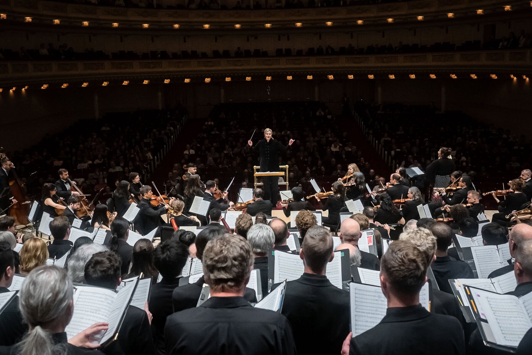 Kathleen Adams conducts the orchestra and chorus during their Memorial Day performance at Carnegie Hall. 