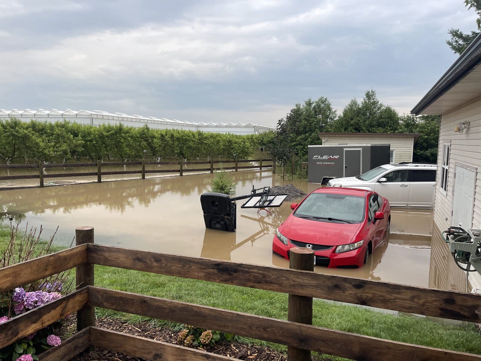 Floodwater surrounds a car outside Rene Flear’s Firelane 13 home.