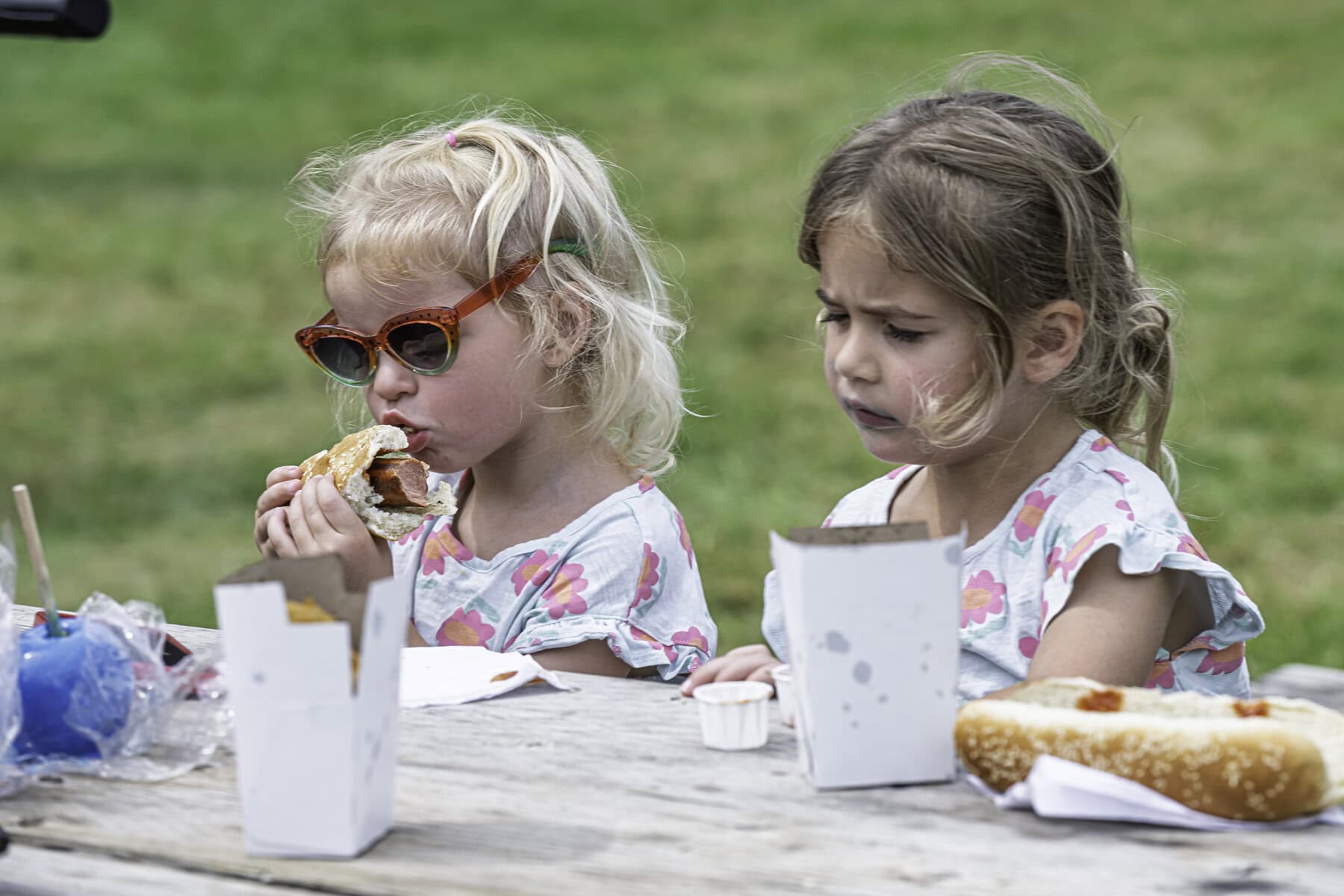 Abby McSween, 2 and Ella McSween, 4, get their grub on with some hot dogs.