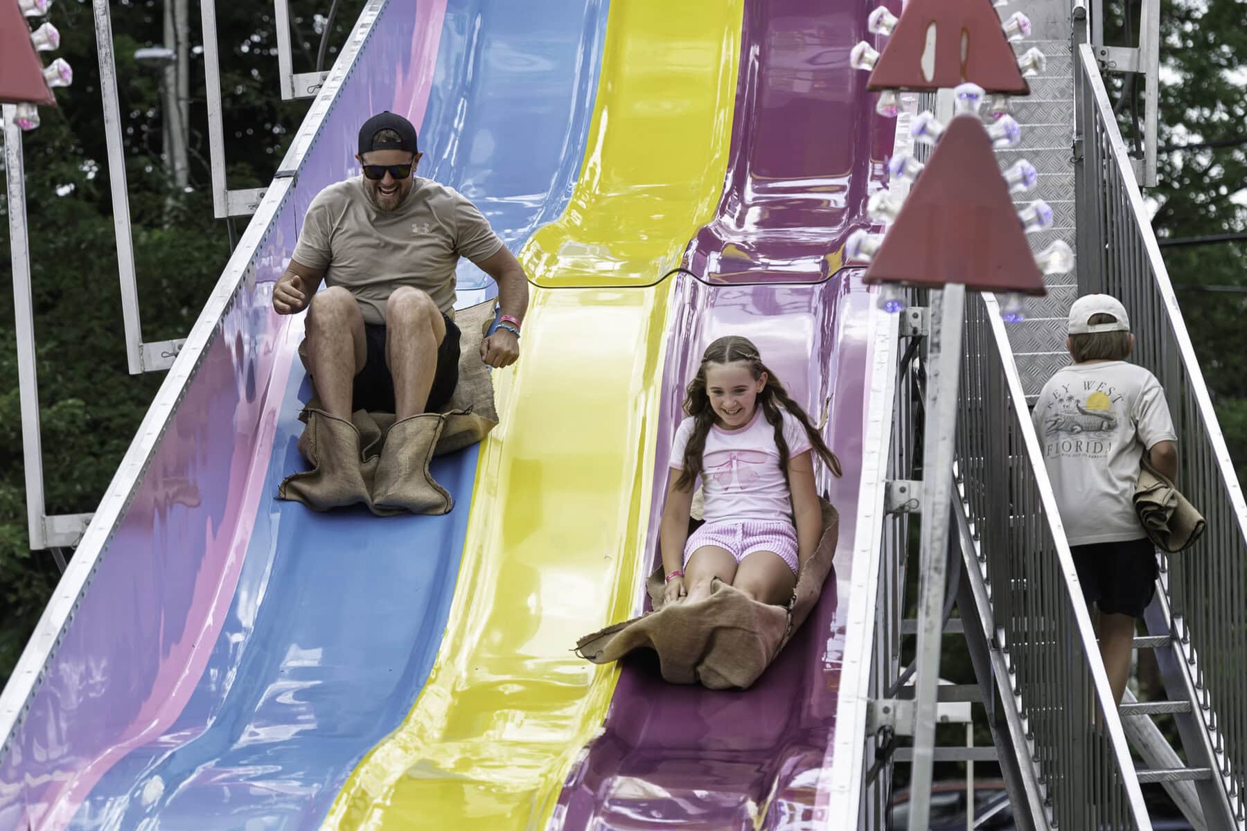 Brad Enderby and his daughter, 10-year-old Emma, are all smiles as they zoom down the slide.