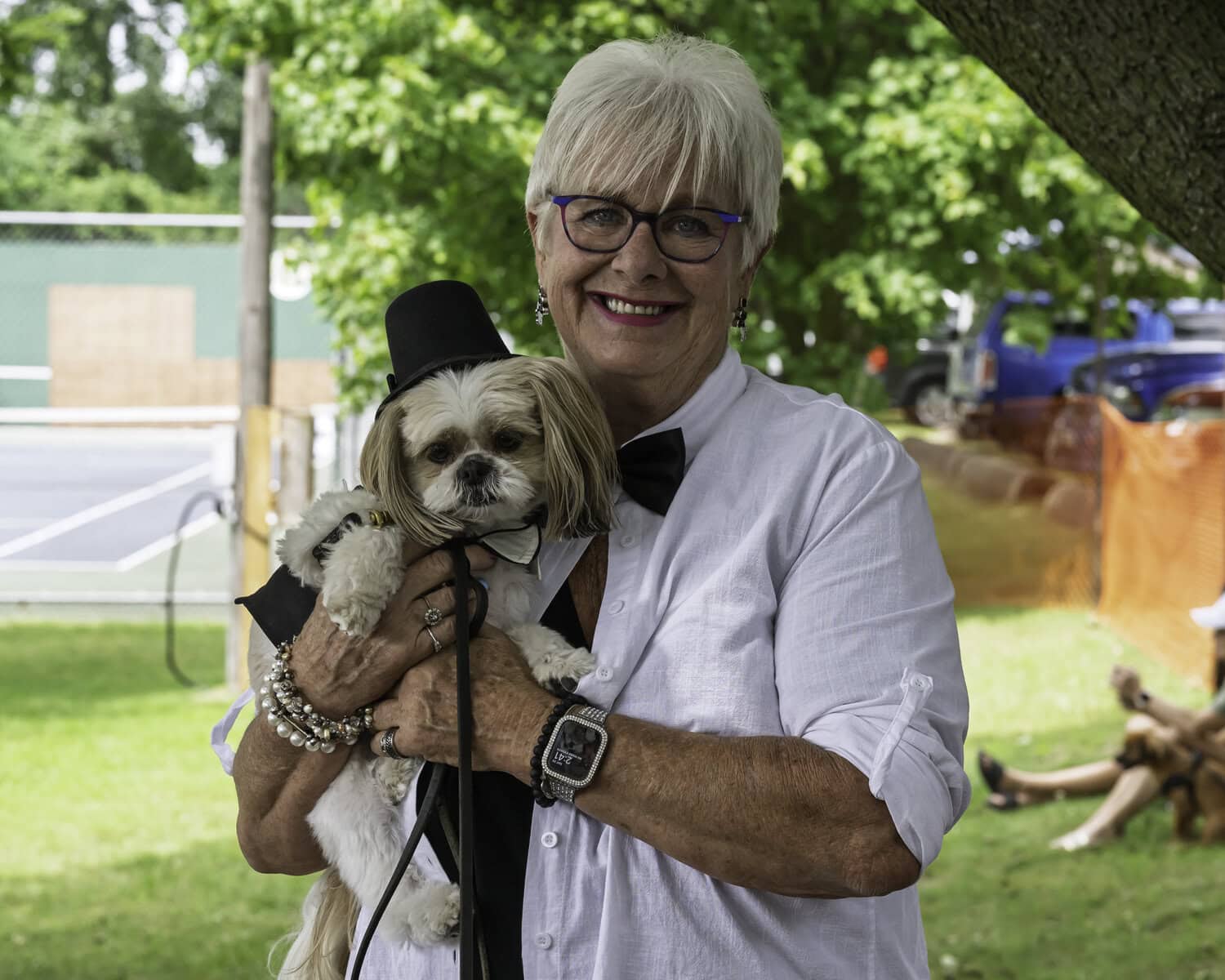 Cosmo the dog, a Shitzu, looking especially dapper in his top hat, being held by his owner, Mary MacPherson.