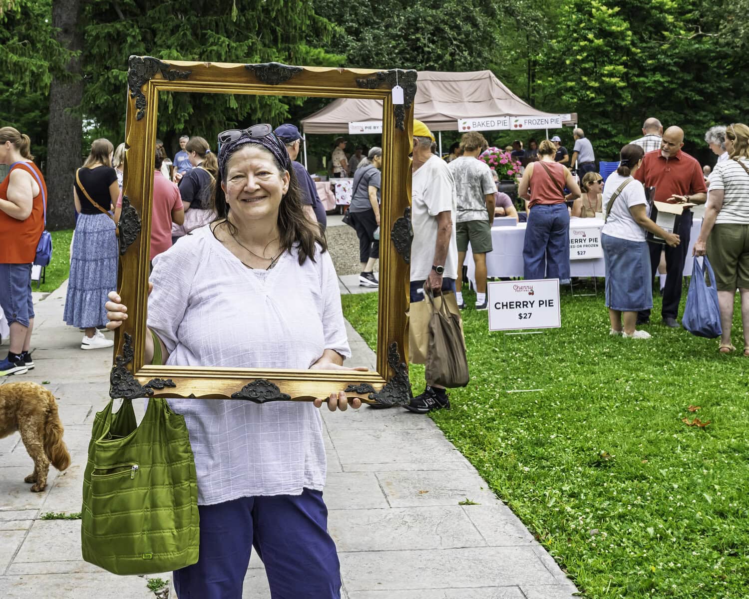 Leslie McNab shows off the frame she purchased inside the church from its Attic Treasures sale.